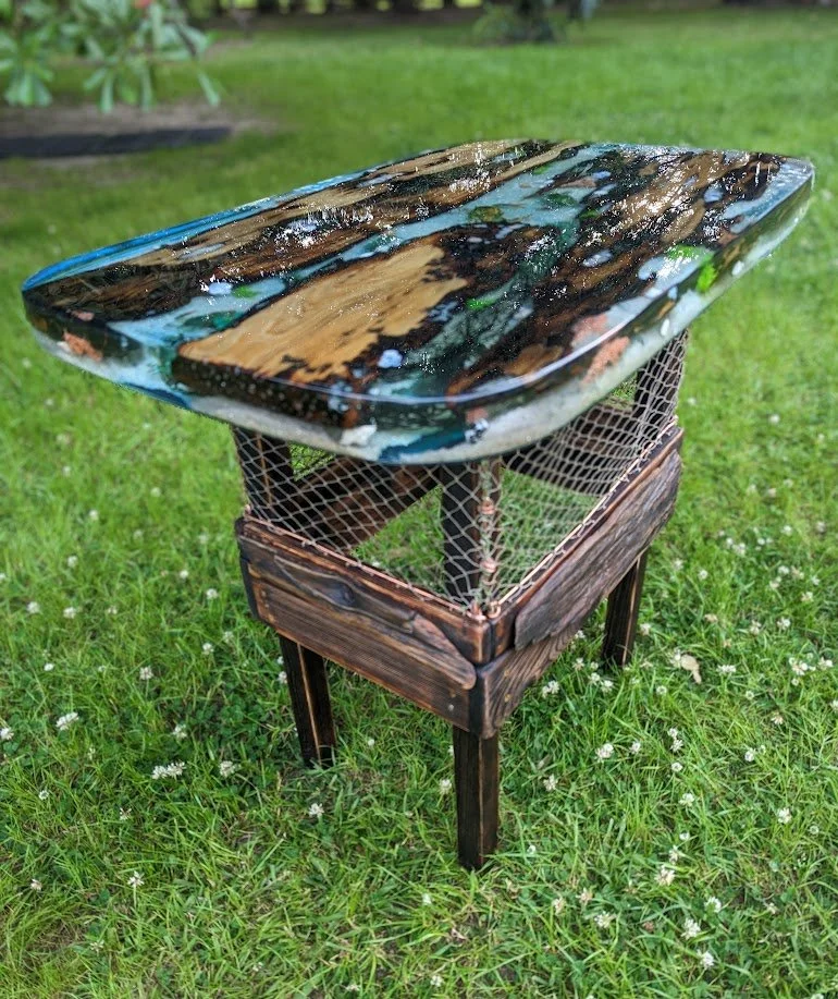🔴 Sold:
Crab Trap Tide Pool Epoxy Table by Art Illusions by Young, Folsom, Louisiana. This functional art table features live-edge pecky and sinker cypress wood encased in clear epoxy that creates a realistic tide pool scene. A traditional crab trap