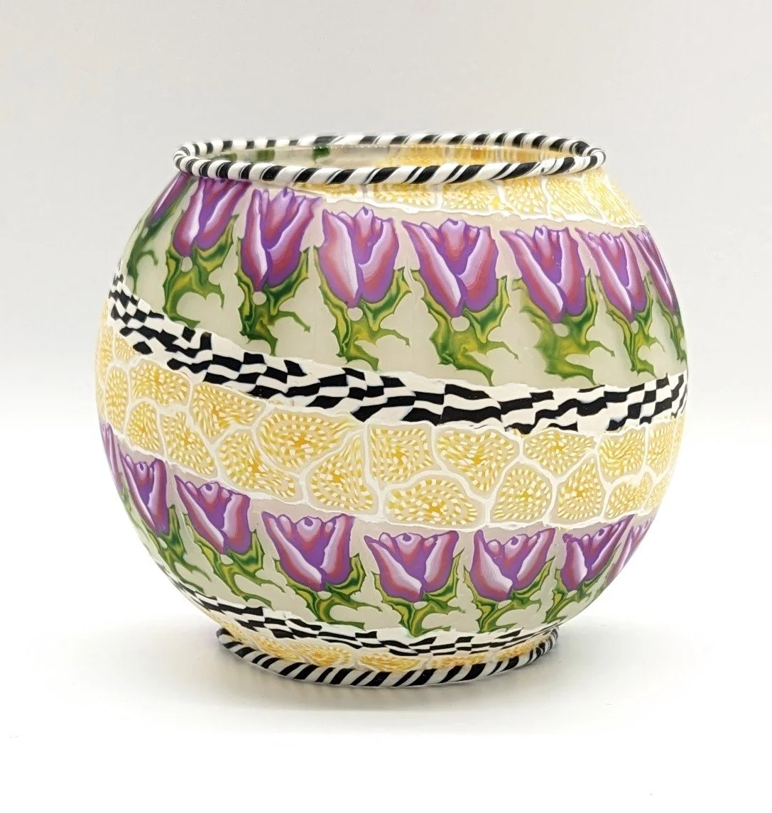 🔴 Sold: 
Polymer Clay Covered Bowl by Art Illusions by Young. This decorative bowl is fully covered in hand-sculpted polymer clay with intricate purple and cream patterns, creating a textured, one-of-a-kind vessel. The rich Mardi Gras-inspired desig