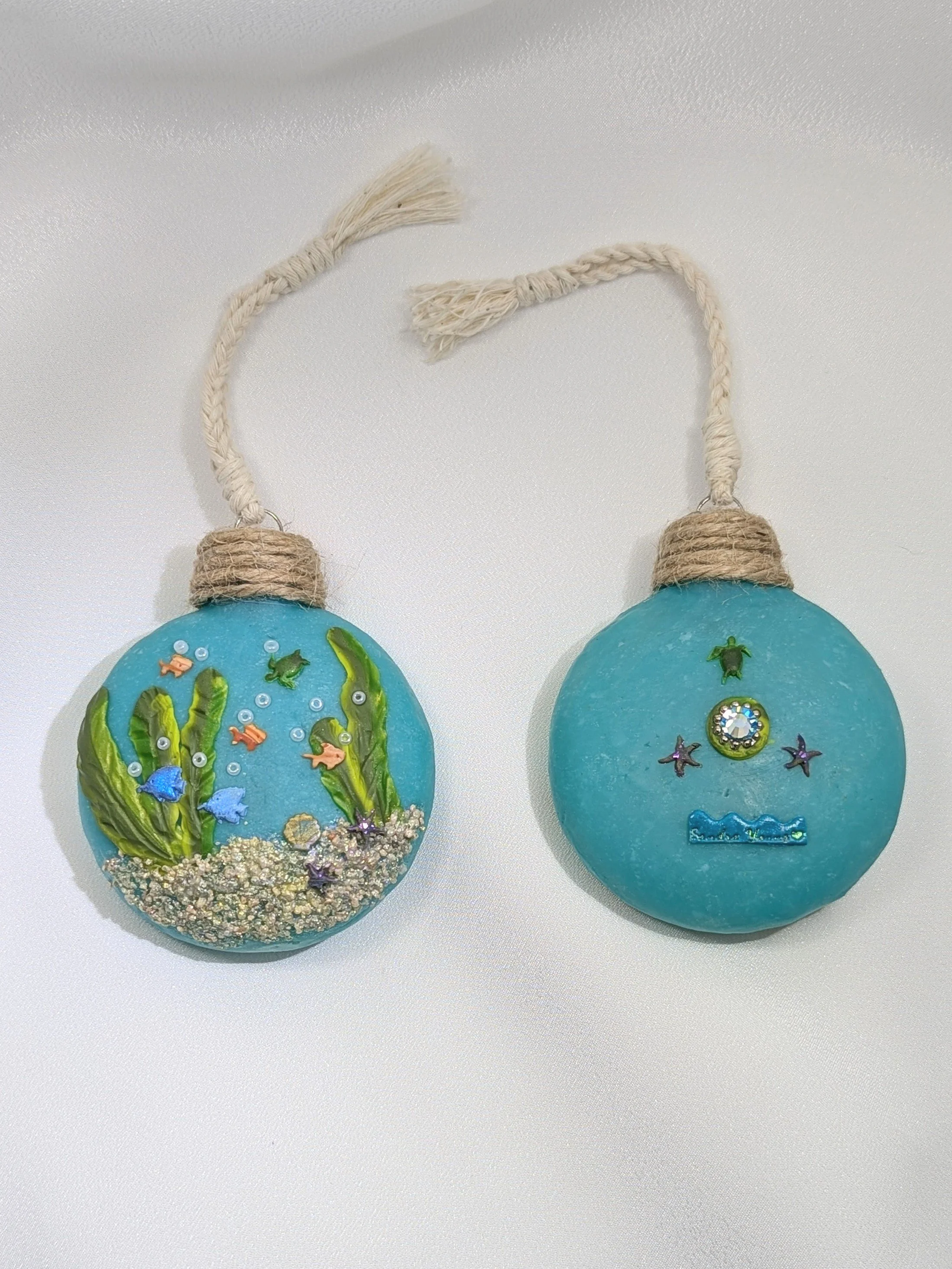 🔴 Sold: 
Turquoise Christmas Ornaments by Art Illusions by Young. A festive turquoise spherical ornaments with sparkling accents and a decorative topper. Handcrafted in polymer clay, it brings bright holiday color and elegant detail to any tree or d
