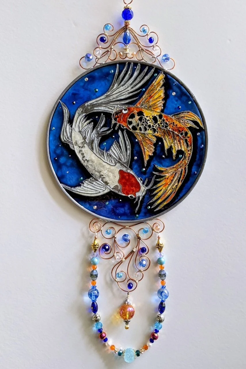 🔴 Sold: 
Butterfly Koi Pond Illusion Glass by Art Illusions by Young. Two colorful butterfly koi glide gracefully in this serene circular suncatcher. The vibrant orange, white, and black patterns shimmer against the deep blue pond background.