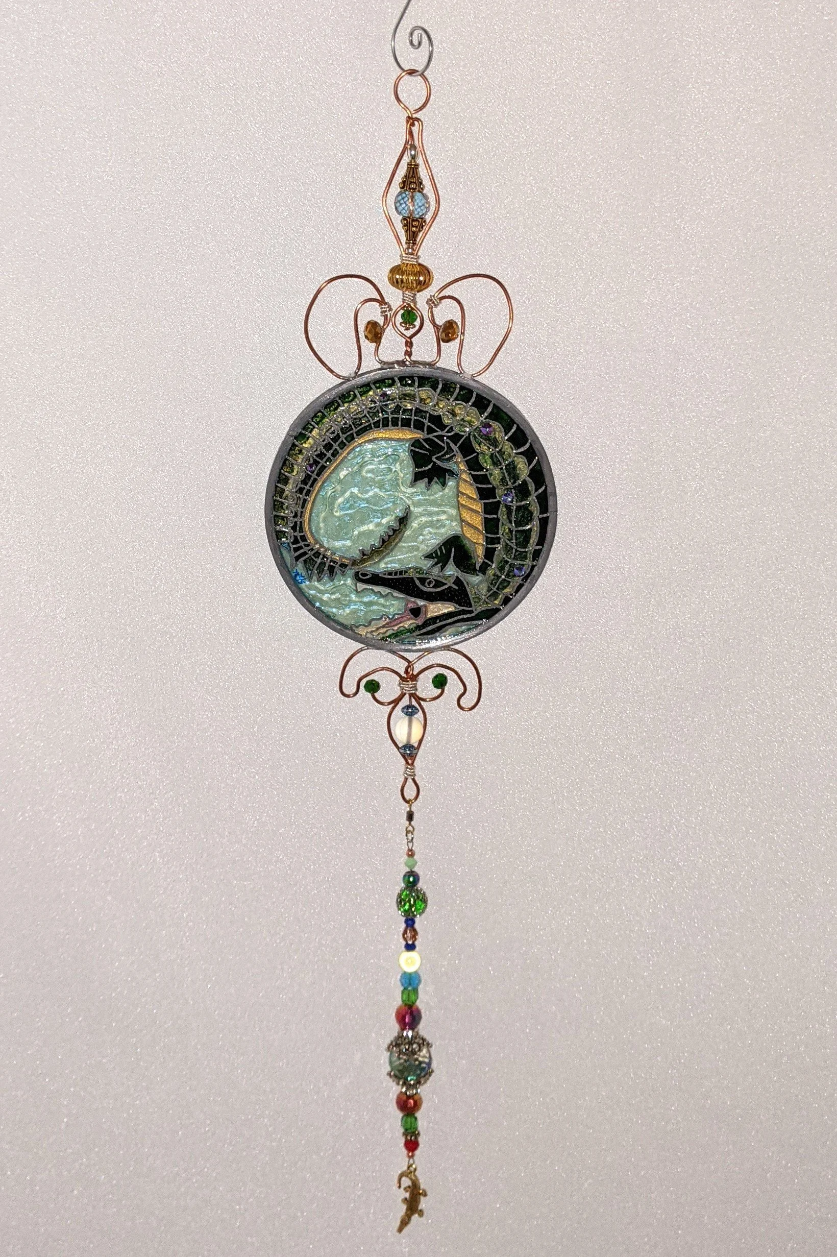 Alligator in Art Nouveau Style by Art Illusions by Young. A powerful Louisiana alligator coils with open jaws in this hand-painted and leaded Illusion Glass panel, rendered in classic Art Nouveau elegance. The gator’s textured scales, sharp teeth, an