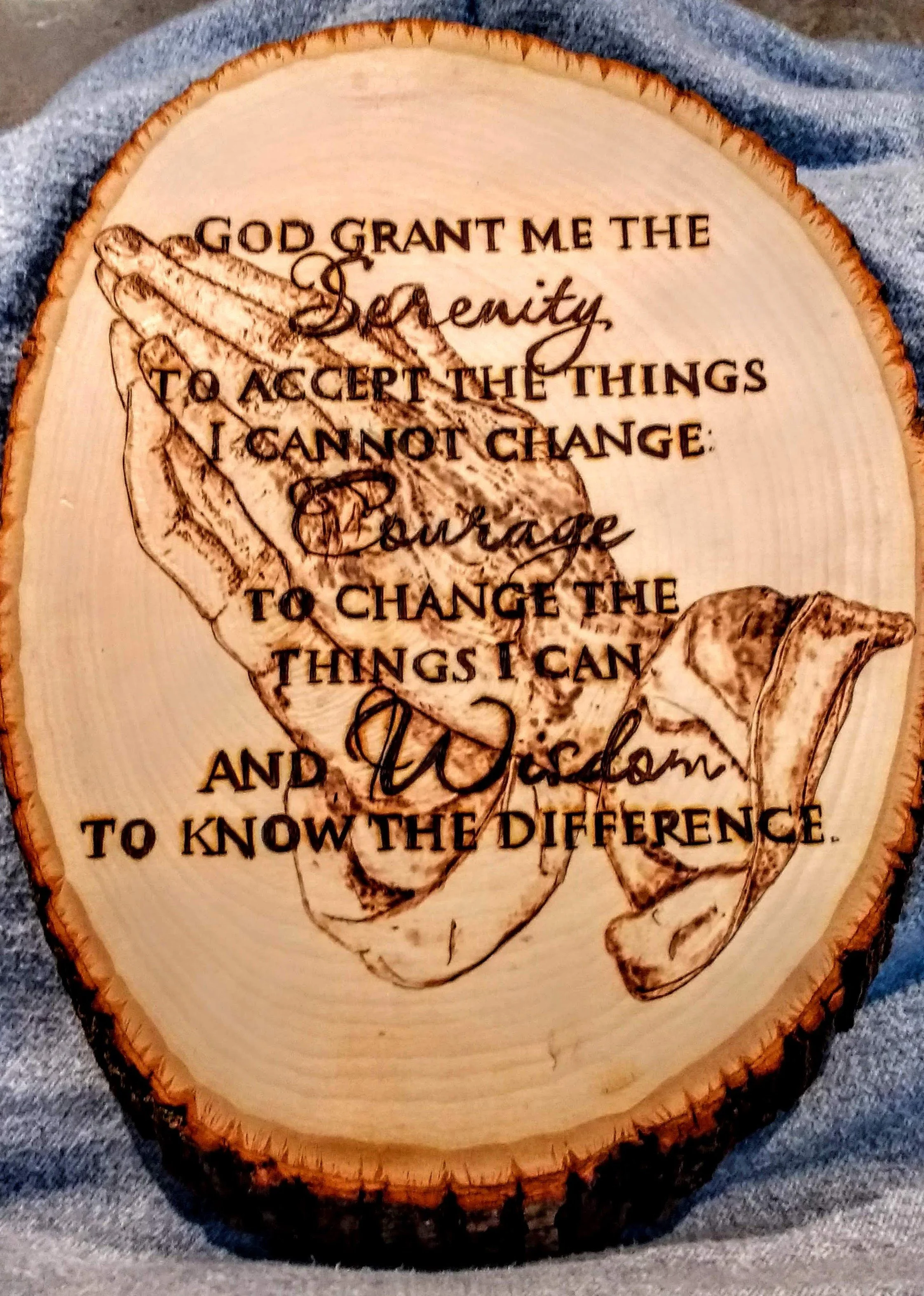 🔴 Sold:
God Grant me Serenity Prayer Pyrography. Serenity Prayer woodburn on wood slice by Art Illusions by Young. Inspirational pyrography piece featuring the full Serenity Prayer text elegantly burned into a round wood slice, accompanied by symbol