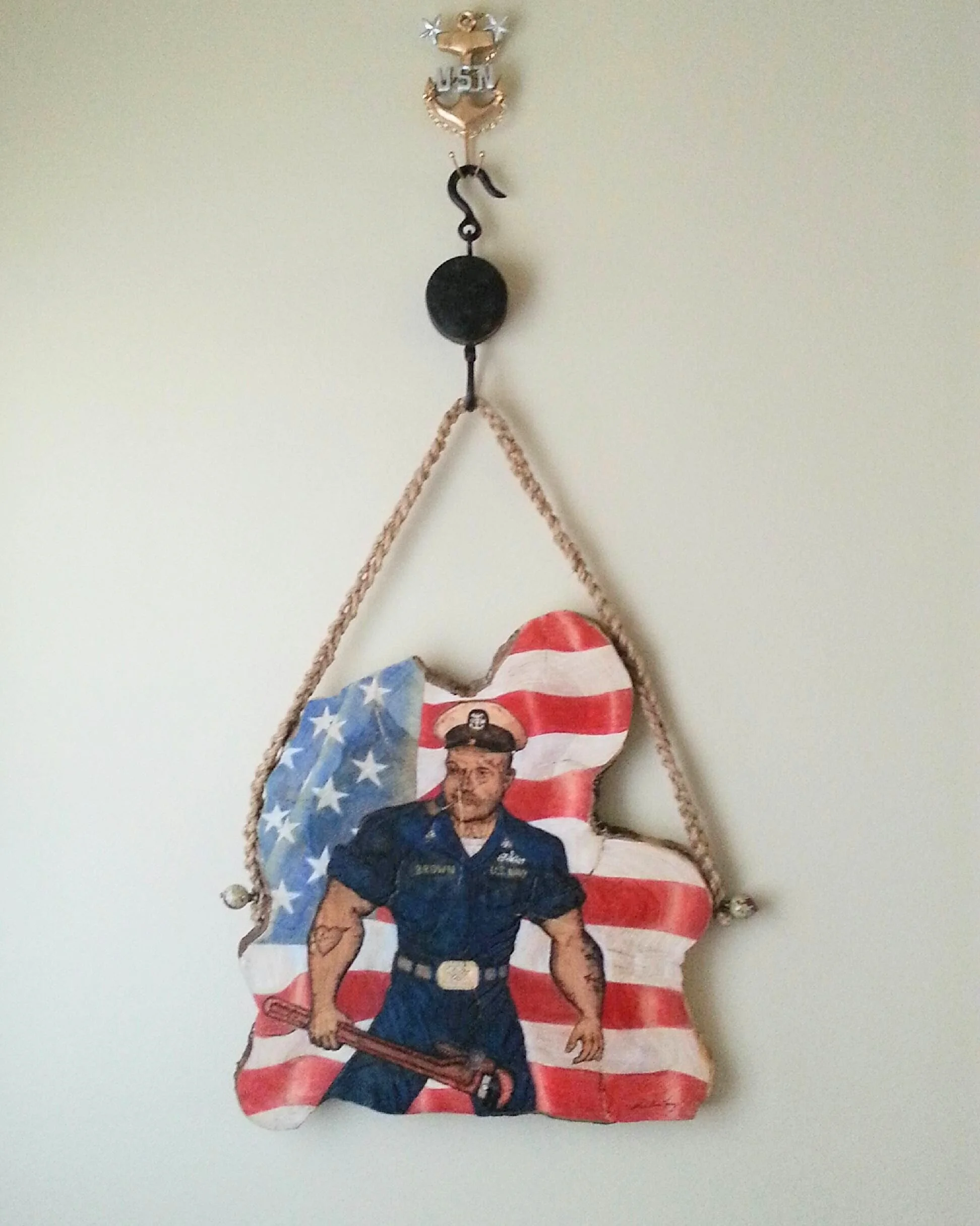 🔵Donated: Nebraska Regional Airport 
In Honor of Command Master Chief Doug Brown Pyrography by Art Illusions by Young, Folsom, Louisiana. This powerful tribute on a cross-cut sinker cypress slice features a proud U.S. Navy sailor standing before a w