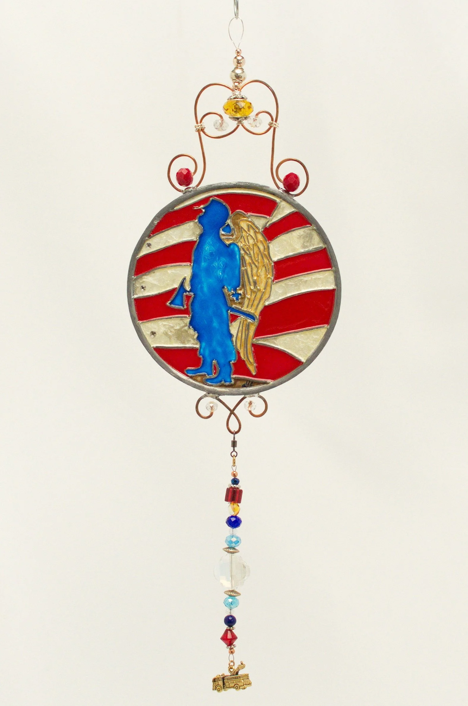 🔴 Sold: 
Guardian Angel Fireman Illusion Glass by Art Illusions by Young. This protective circular suncatcher depicts a guardian angel  firefighter, rendered with deep blues, reds, and warm golden light. A meaningful tribute created with European gl