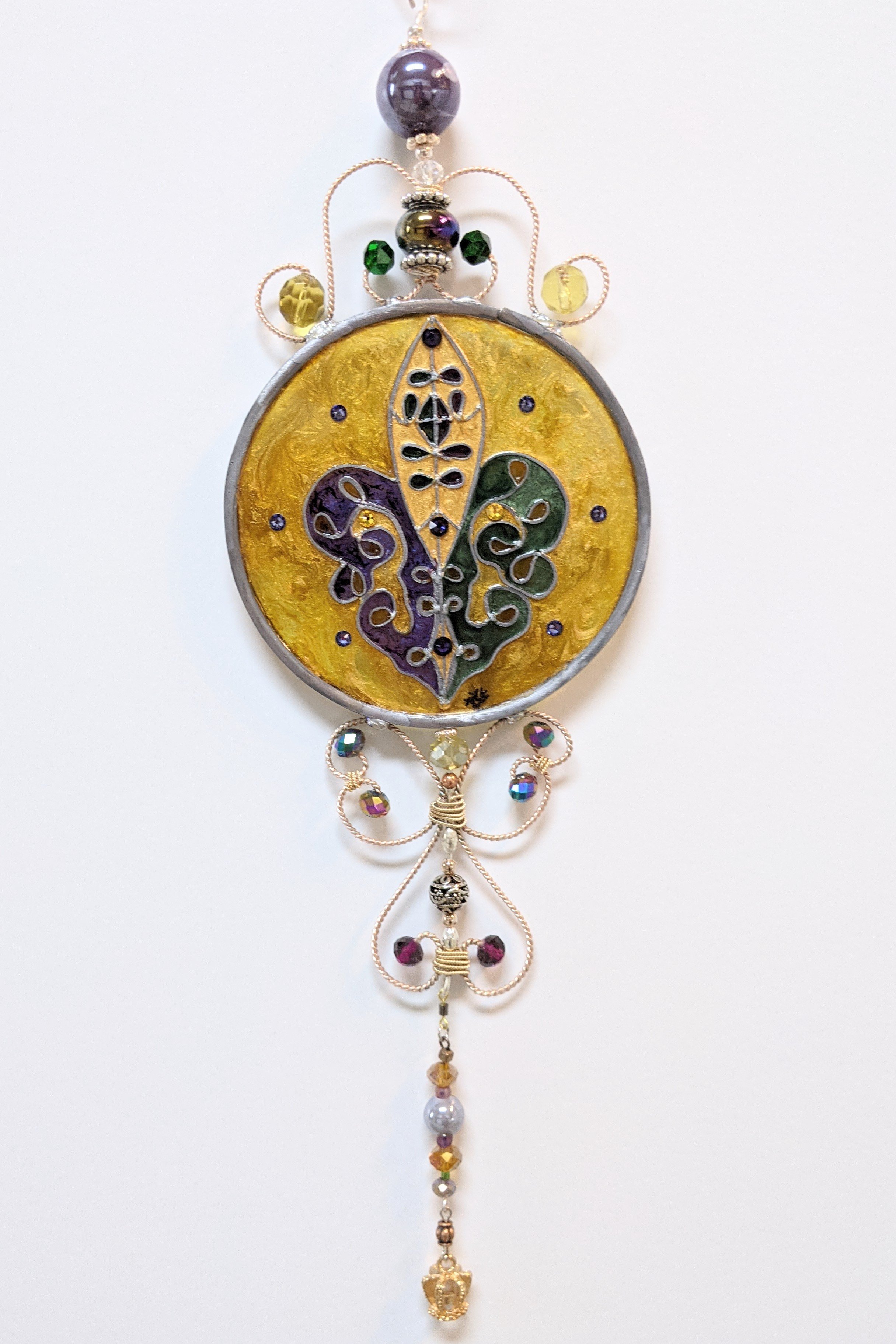 🔴 Sold: 
Fleur-de-Lis Illusion Glass by Art Illusions by Young. A bold diamond-shaped suncatcher centered on the iconic Louisiana fleur-de-lis, surrounded by intricate decorative motifs in vibrant Mardi Gras colors. A proud celebration of Crescent C