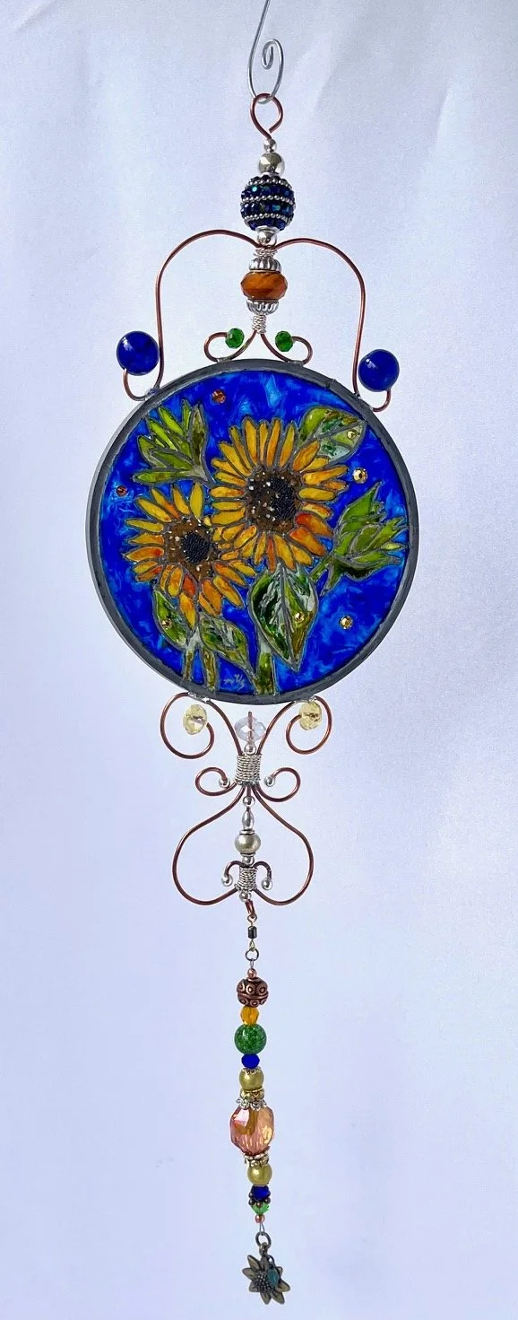 🔴 Sold: 
Sunflowers Illusion Glass by Art Illusions by Young. A bright bouquet of sunflowers with soft petals and green stems glows in this circular suncatcher. The fresh, uplifting design creates a gentle luminous effect that brings natural joy to 