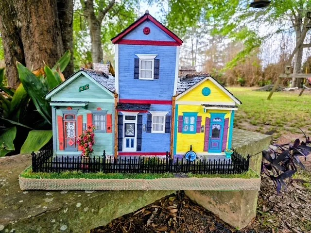Rear view of the handcrafted Triple New Orleans Shotgun House Row diorama by Art Illusions by Young. This perspective reveals the detailed rear architecture of the three shotgun houses, including varied rooflines, chimneys, back doors and windows, co