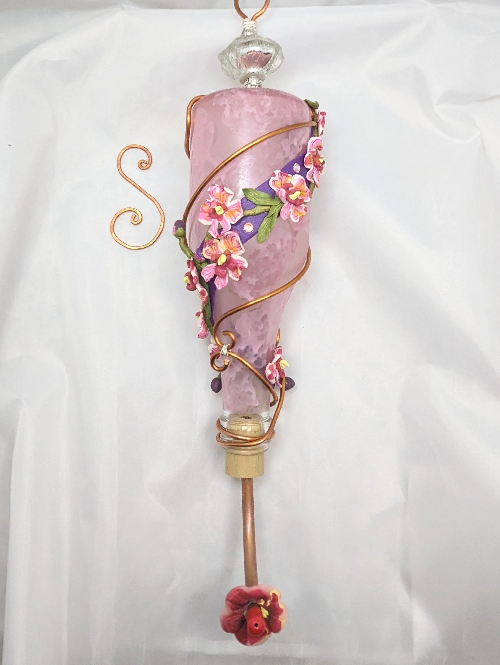 🔴 Sold: 
Pink Swirl Hummingbird Feeder with Pastel Blooms by Art Illusions by Young, Folsom, Louisiana. Delicate pink glass forms the base of this tall, gracefully spiraled hummingbird feeder, embellished with hand-sculpted polymer clay flowers in s