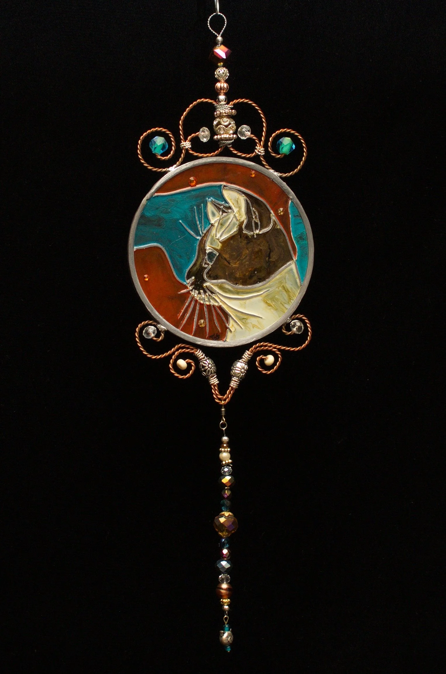Calico Cat by Art Illusions by Young against a dark background. A beautiful calico cat sits gracefully in this hand-painted and leaded Illusion Glass panel. Its distinctive coat—warm orange and soft white patches—is dramatically highlighted against t