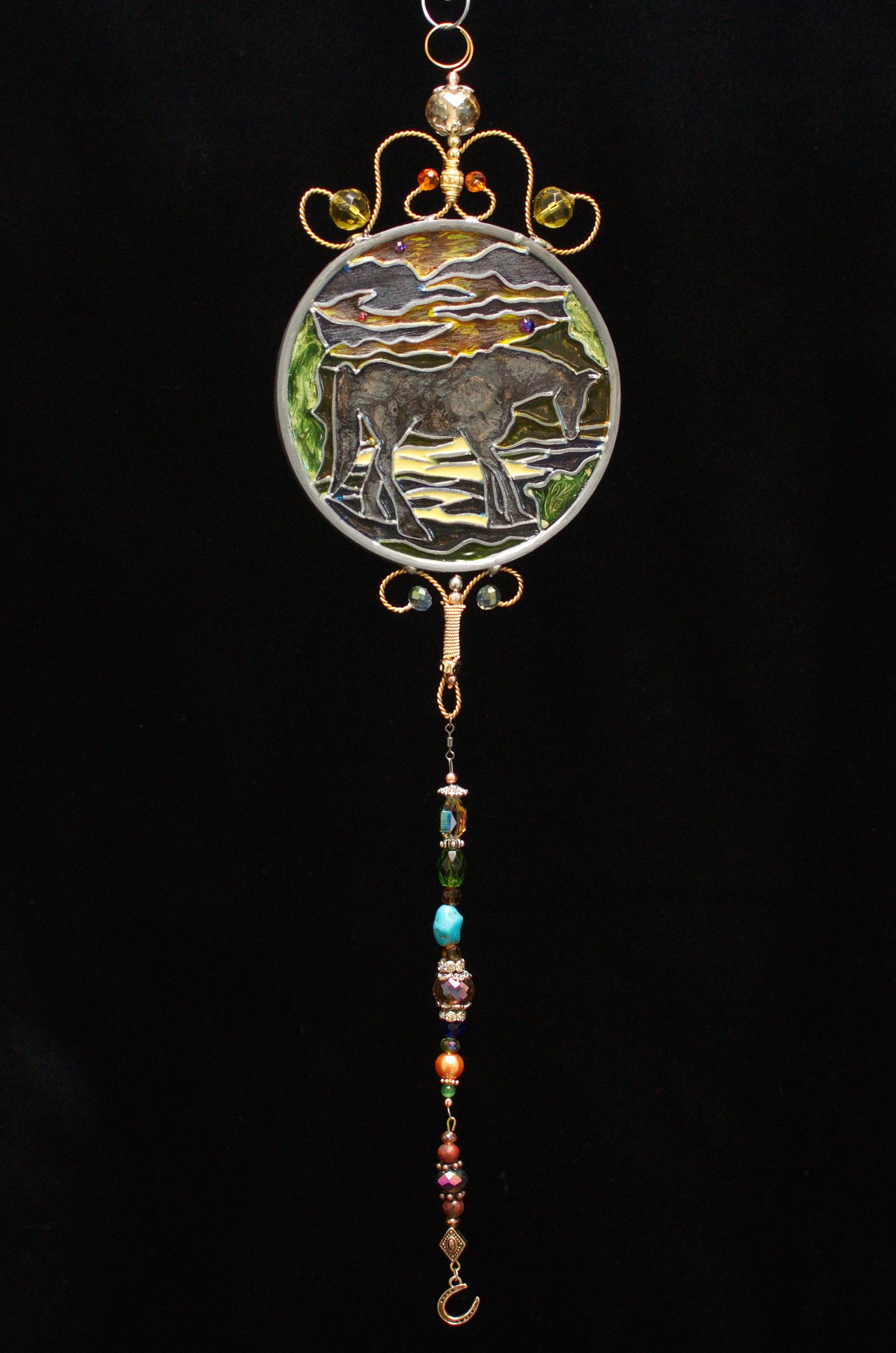 Horse Silhouette by Art Illusions by Young against a dark background. A graceful horse stands in elegant silhouette against a shifting, luminous sky in this hand-painted and leaded Illusion Glass panel. The dark backdrop dramatically highlights the s