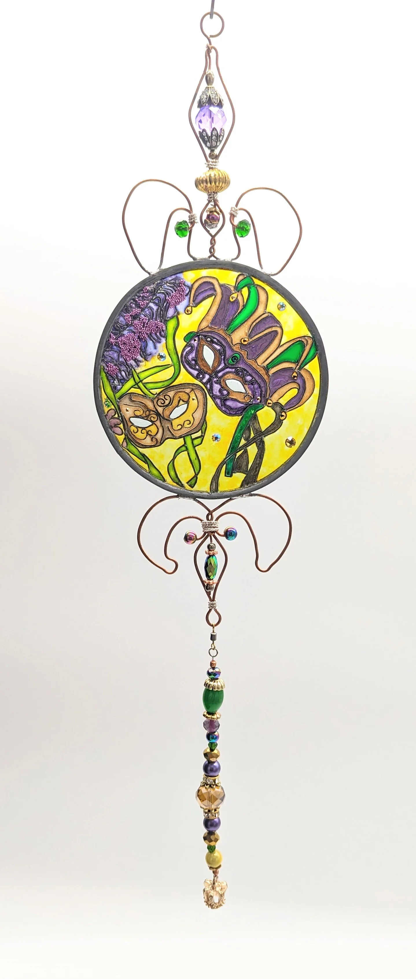 🔴 Sold: 
Mardi Gras Masks Illusion Glass by Art Illusions by Young. Festive Mardi Gras masks in vibrant purple, green, and gold adorn this energetic circular suncatcher. Sparkling accents and bold colors bring the joy and celebration of Carnival to 