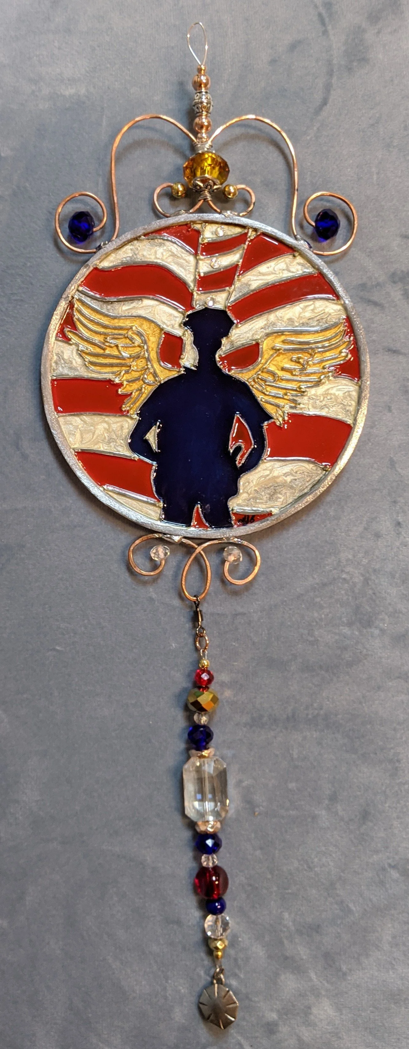 🔴 Sold: 
Guardian Angel Policeman Illusion Glass by Art Illusions by Young. This protective circular suncatcher depicts a guardian angel  police officer, rendered with deep blues, protective gold tones, and a sense of strength and comfort. A meaning