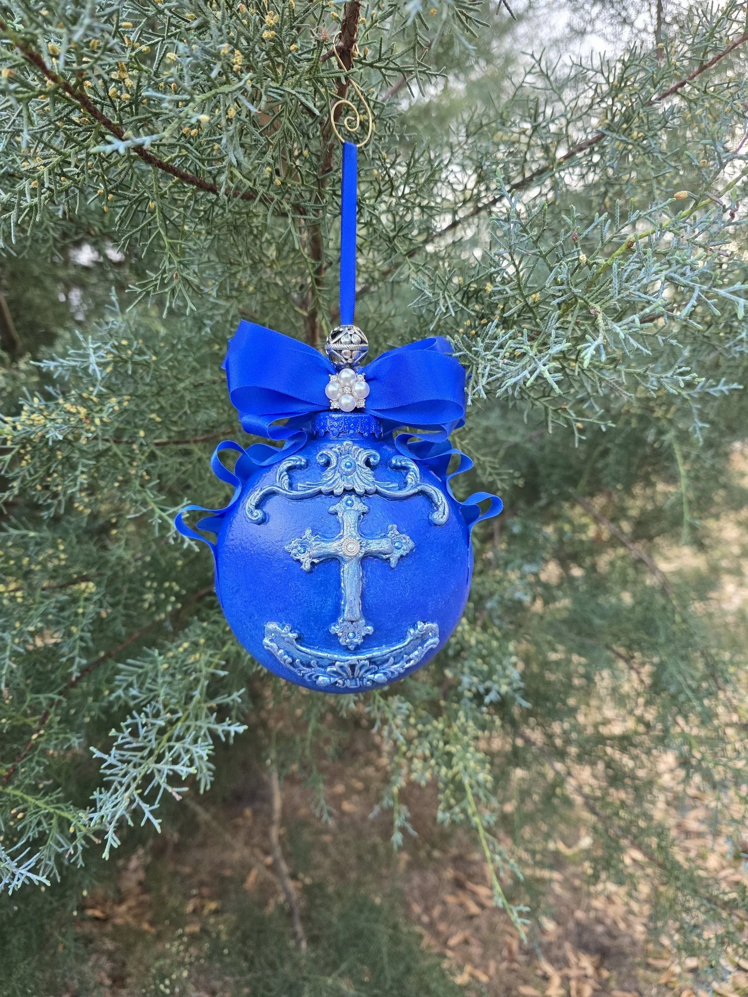 Royal Blue Cross Ornament – Sacred Elegance in Cobalt by Art Illusions by Young from Folsom, Louisiana. A luminous cobalt blue background on an ornate silver cross with intricate filigree and scrollwork that catches light with every movement. Delicat