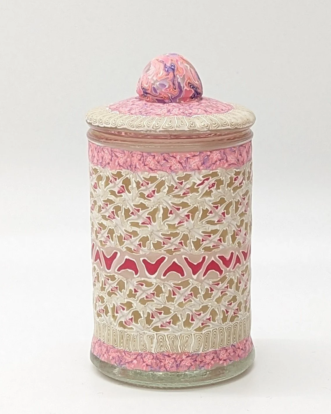 🟢 Available :
Floral Lace Trinket Jar by Art Illusions by Young from Folsom, Louisiana. This hand-sculpted clay covered cylindrical jar features a delicate lace-like pattern in soft cream with accents of pink and gold, evoking vintage textiles and t