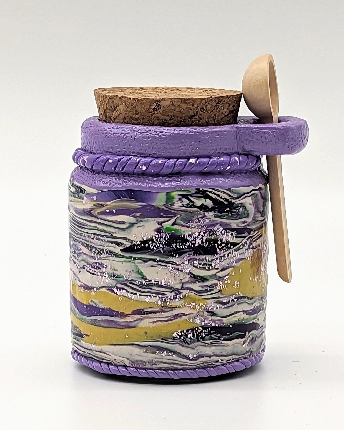 Mardi Gras Honey Jar – Swirling Carnival Majesty by Art Illusions by Young from Folsom, Louisiana. This hand-sculpted clay over glass jar captures the vibrant energy and regal palette of Carnival through bold, swirling layers of deep royal purple, sh