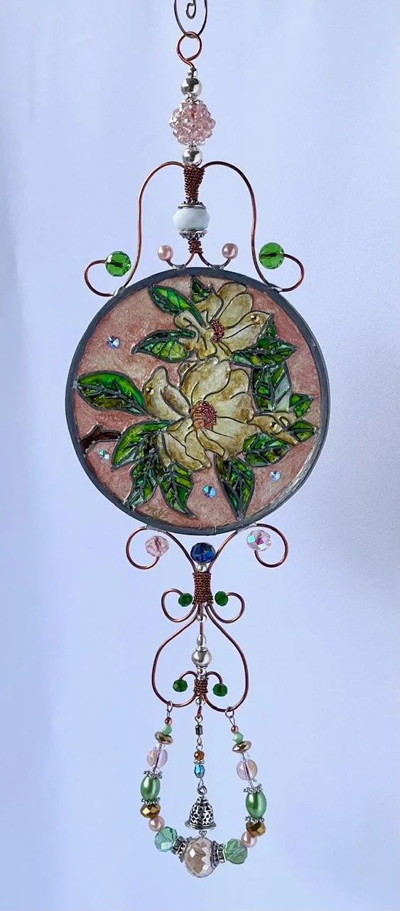 🔴 Sold: 
Magnolias Illusion Glass by Art Illusions by Young. Creamy white magnolia blossoms with lush green leaves fill this elegant round suncatcher. The soft, painterly style captures the timeless beauty and Southern grace of Louisiana’s state flo