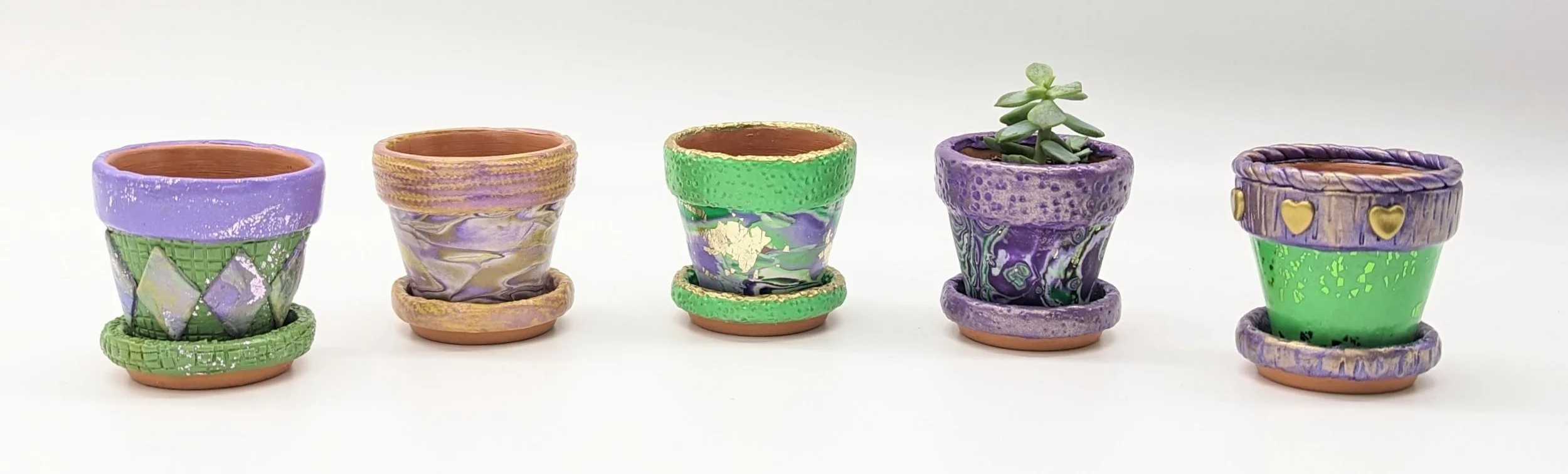 🟢 Available :
Miniature Clay Pots Collection by Art Illusions by Young, Folsom, Louisiana. This photo of five different hand-sculpted polymer clay covered micro pots showcases vibrant Mardi Gras-inspired color palettes and intricate surface details.