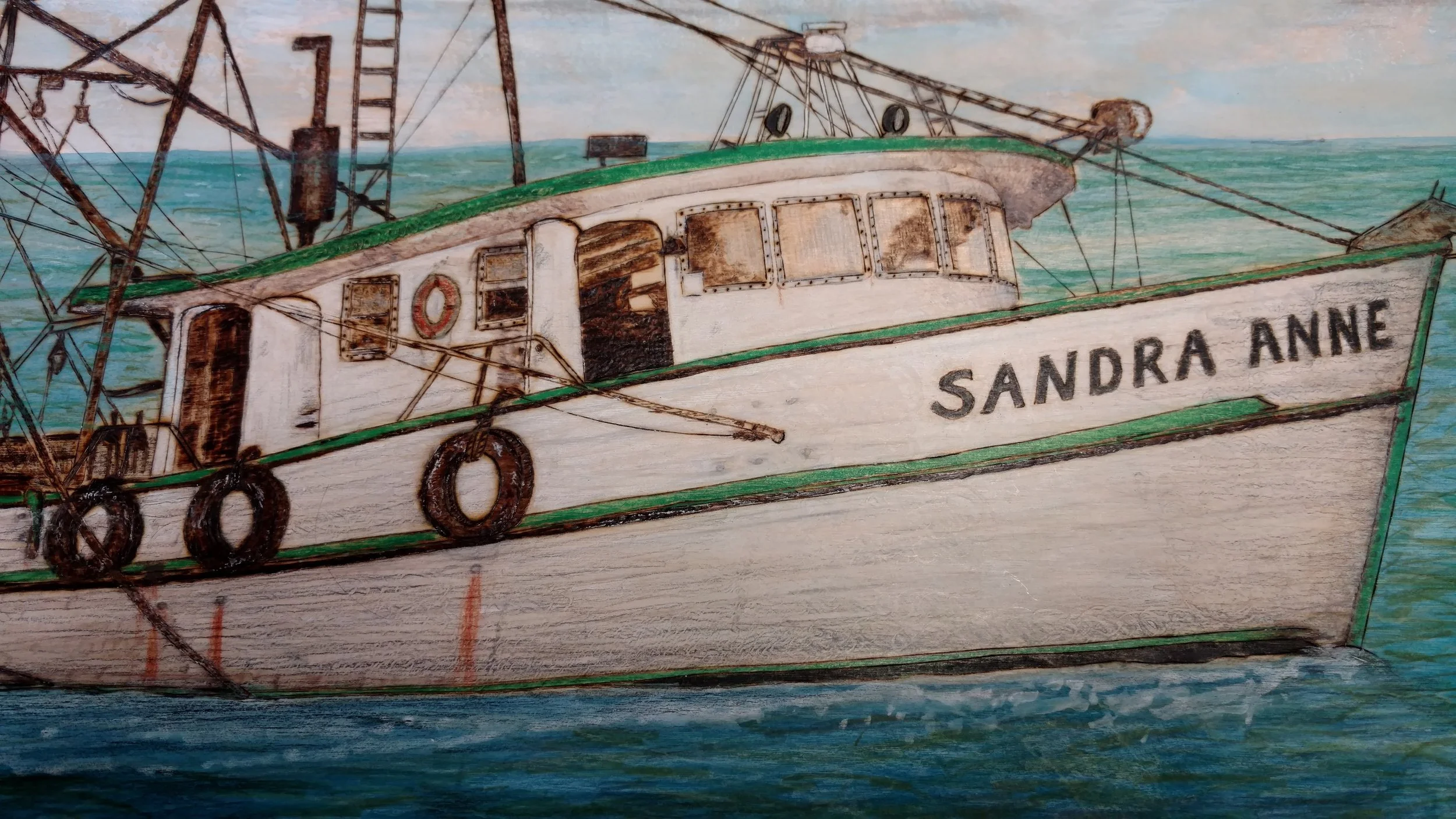 Close-up detail of the hand-burned shrimp boat artwork by Art Illusions by Young. Fine pyrography lines define the vessel’s structure, rigging, and deck details, while carefully applied pigments bring realistic depth to the hull and water. This intim