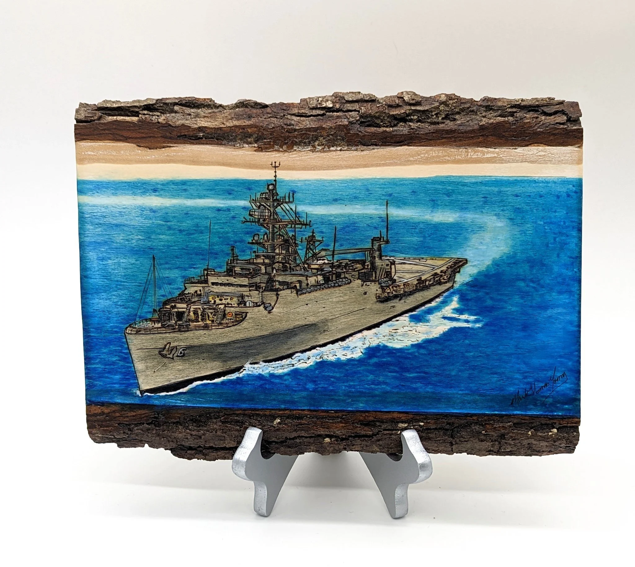 🔴 Sold:
USS Duluth LPD-6 Underway Coming About Pyrography by Art Illusions by Young, Folsom, Louisiana. This dynamic woodburn on a natural wood slice captures the Austin-class amphibious transport dock USS Duluth (LPD-6) underway and coming about, h