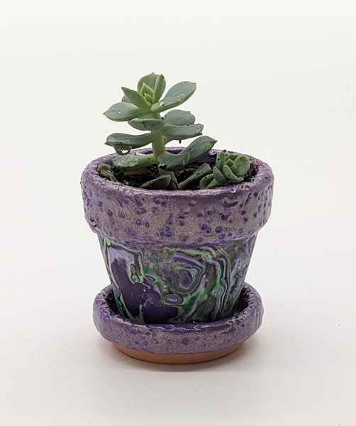 🔴 Sold: 
Mini Mardi Gras Polymer Clay Flower Pot by Art Illusions by Young. A small flower pot adorned with hand-sculpted polymer clay in rich purple and gold Mardi Gras colors. The miniature scale and festive details make it a charming succulent or