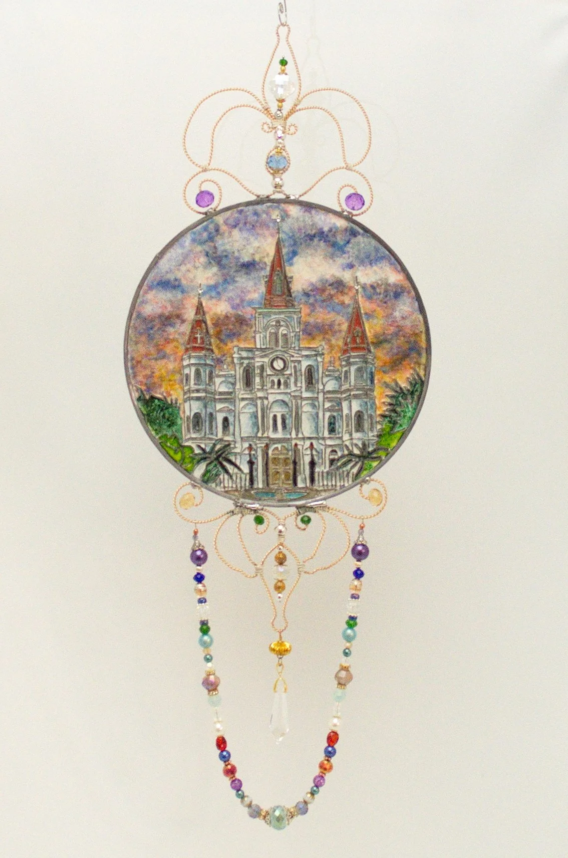 🔵 Donated : 
St. Louis Cathedral Illusion Glass by Art Illusions by Young. This iconic New Orleans landmark is beautifully captured in a circular suncatcher against a dramatic sunset sky. The architectural details and warm color palette evoke the he