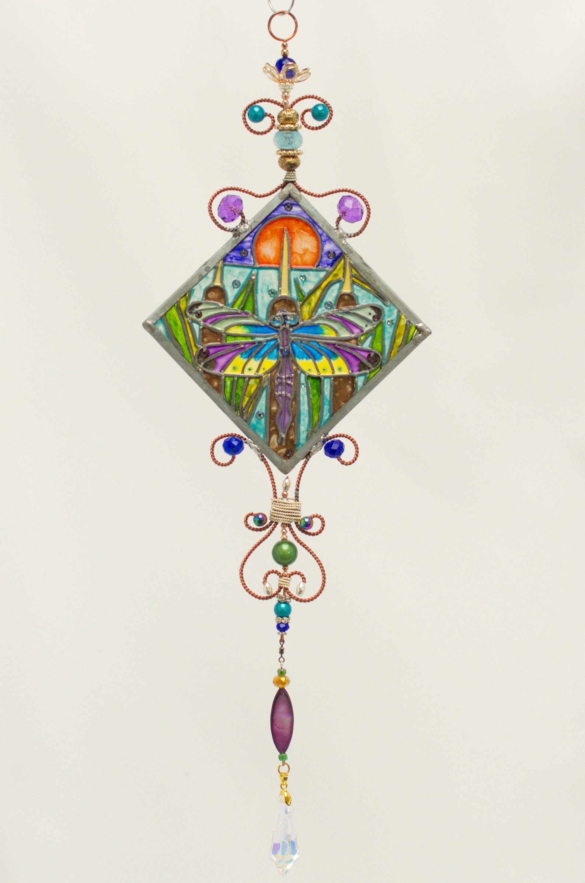 🔴 Sold: 
Dragonfly Illusion Glass by Art Illusions by Young. A graceful dragonfly with iridescent wings hovers in this delicate diagonal suncatcher. European glass paints produce shifting patterns of light and color that capture the insect’s etherea