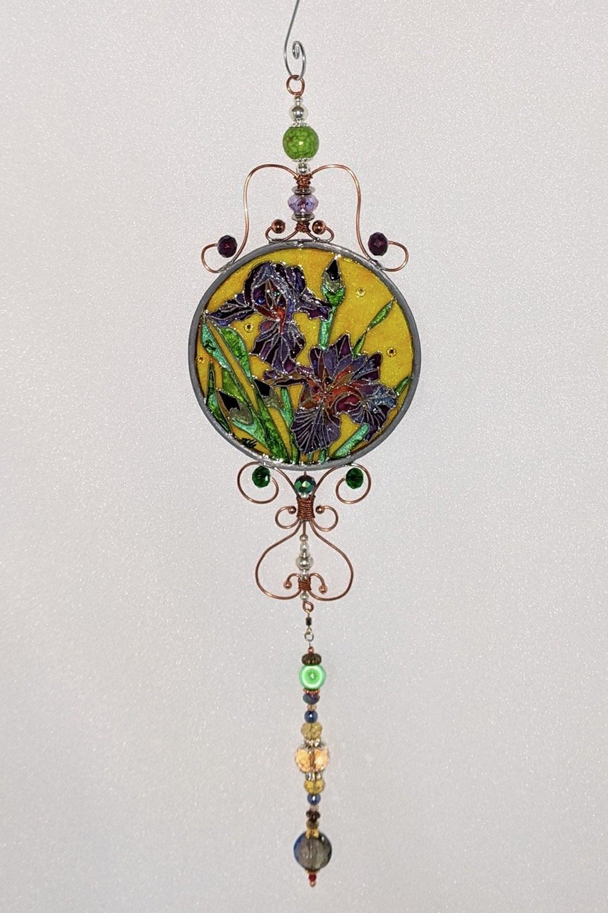 🔴 Sold: 
Louisiana Irises Illusion Glass by Art Illusions by Young. Elegant purple Louisiana irises bloom in this round suncatcher, their petals rendered with rich color and subtle shading. A beautiful tribute to the state flower in glowing painted 