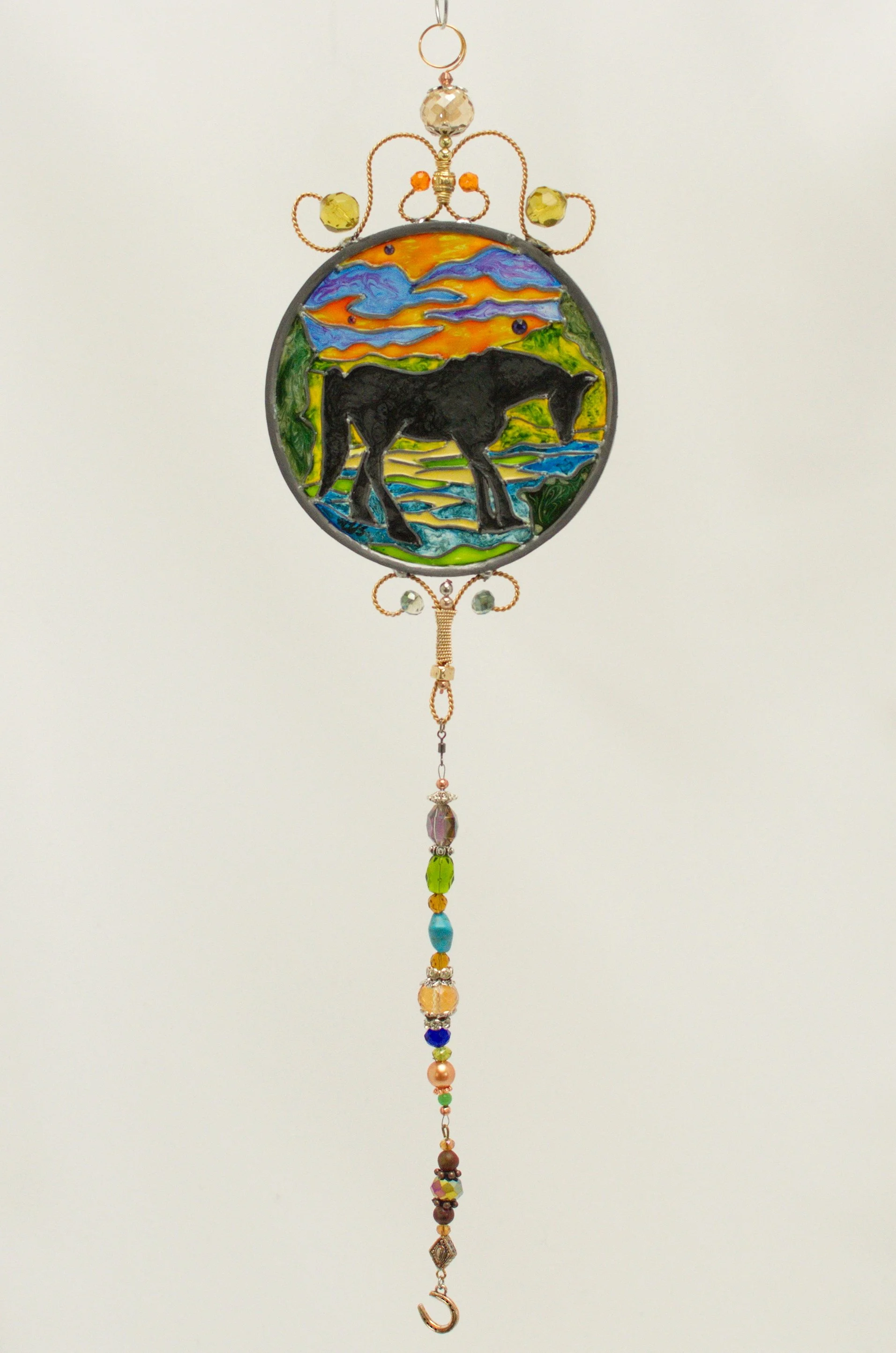 Horse Silhouette by Art Illusions by Young. A graceful horse stands in elegant silhouette against a shifting, luminous sky in this hand-painted and leaded Illusion Glass panel. The strong, flowing lines of the horse’s body and mane are rendered with 