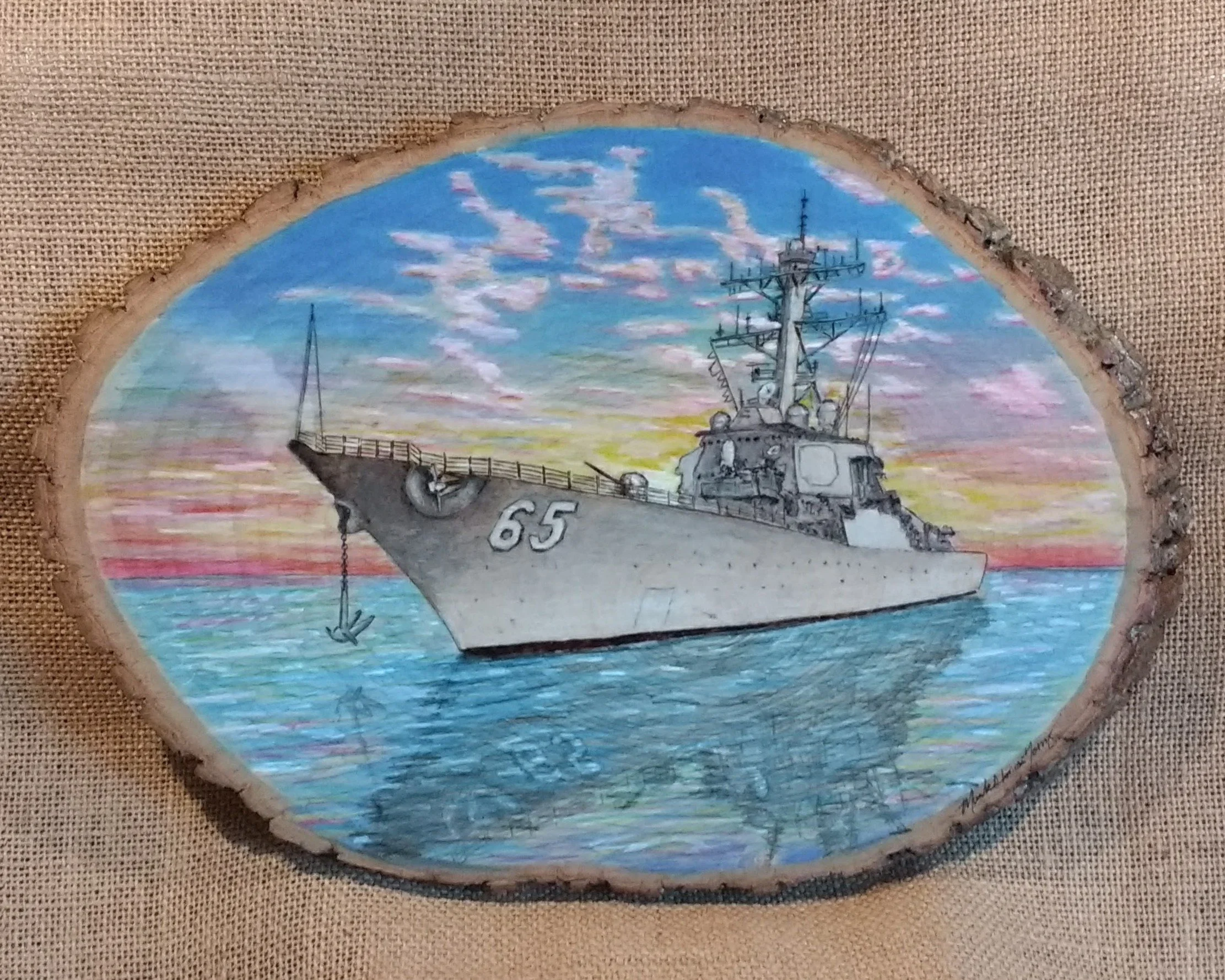 🔴 Sold:
USS Benfold DDG-65 Anchor Up Pyrography by Art Illusions by Young, Folsom, Louisiana. This striking woodburn on a natural wood slice captures the Arleigh Burke-class destroyer USS Benfold at anchor, its bow prominently displaying the number 