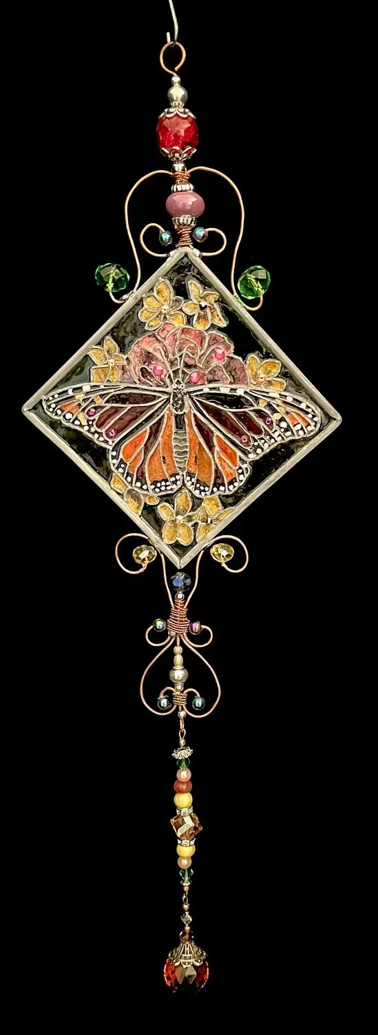 🔴 Sold: 
Butterfly Diamond Illusion Glass by Art Illusions by Young, Folsom, Louisiana. This elegant diamond-shaped suncatcher features a beautifully detailed butterfly with intricate wing patterns in rich orange, brown, and gold tones, surrounded b