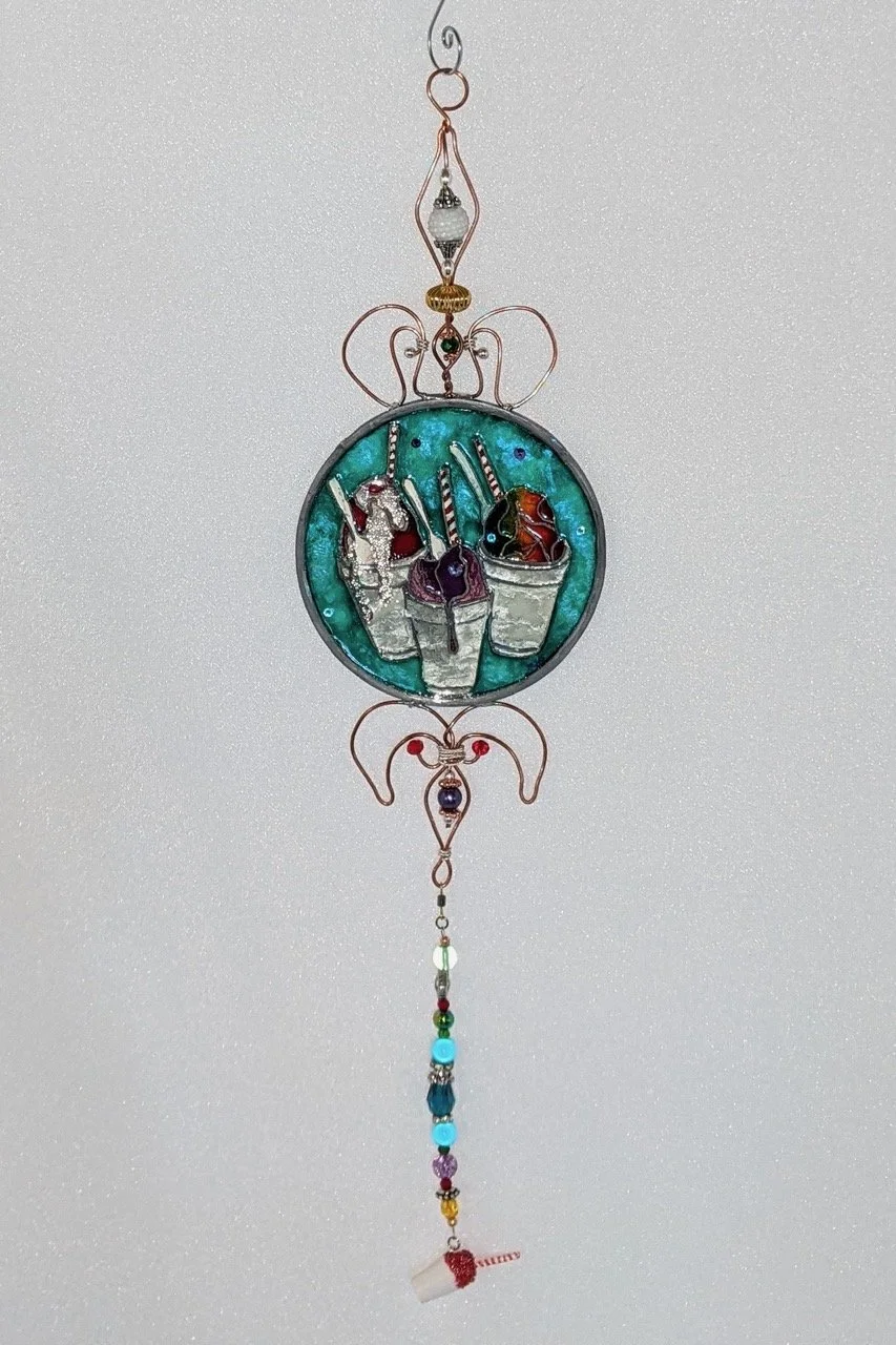 🔴 Sold: 
New Orleans Snowballs Illusion Glass by Art Illusions by Young. This cheerful circular piece depicts classic New Orleans snowballs with colorful syrups. Vibrant hand-painted details evoke sweet summer memories of the Crescent City.