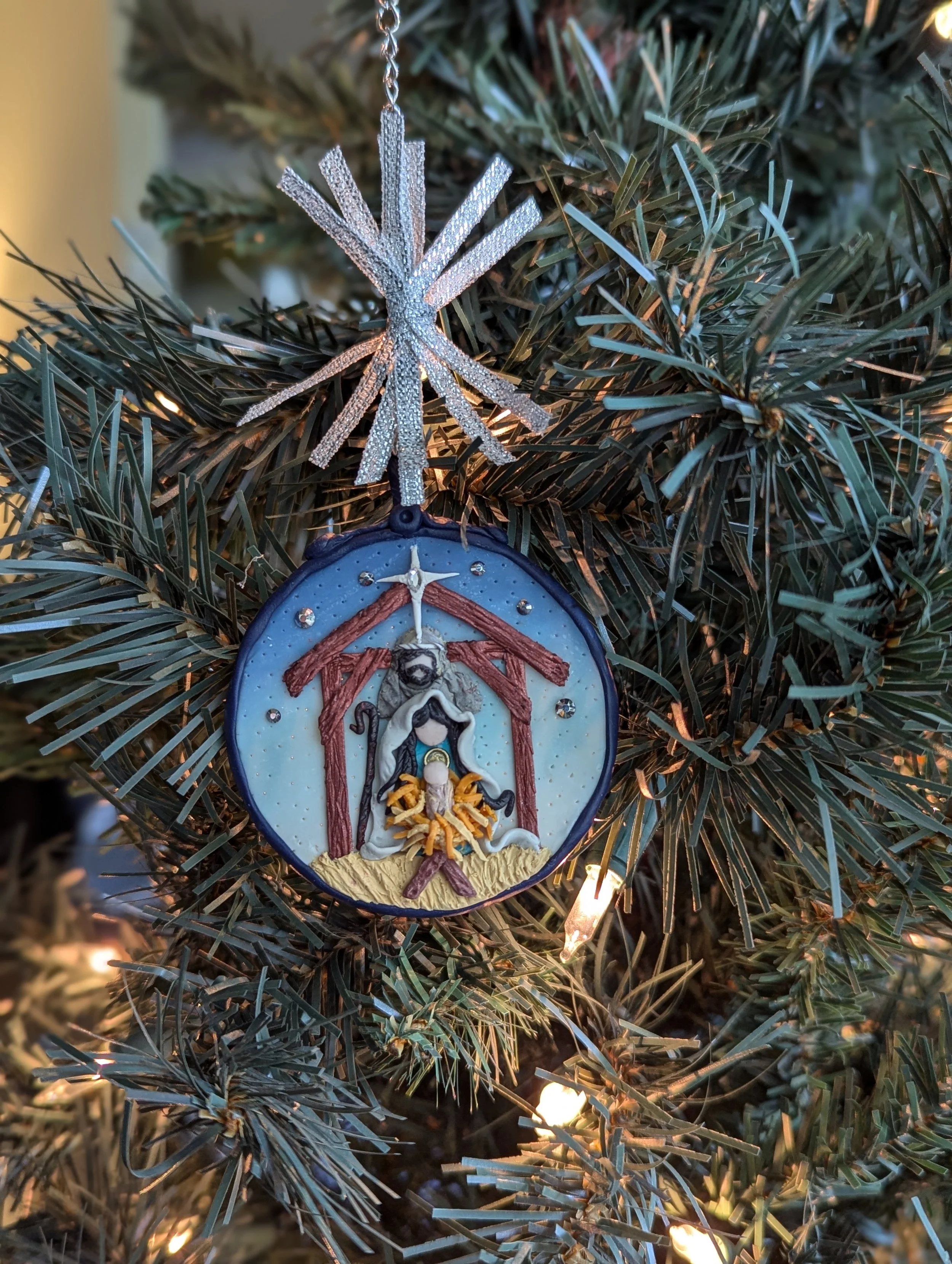 🔴 Sold: 
Manger Ornament by Art Illusions by Young. This touching Christmas ornament features a detailed nativity scene with the Holy Family, rendered in polymer clay with warm, reverent colors. A beautiful addition to any holiday collection that ce