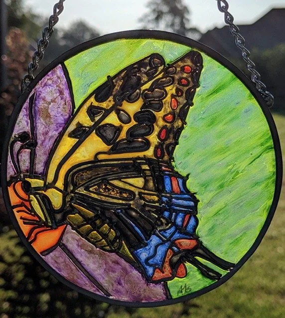 🔴 Sold: 
Swallowtail Butterfly Illusion Glass by Art Illusions by Young. A vibrant swallowtail butterfly with bold black and yellow wing patterns fills this circular suncatcher. The intricate details and luminous European glass paints capture the de