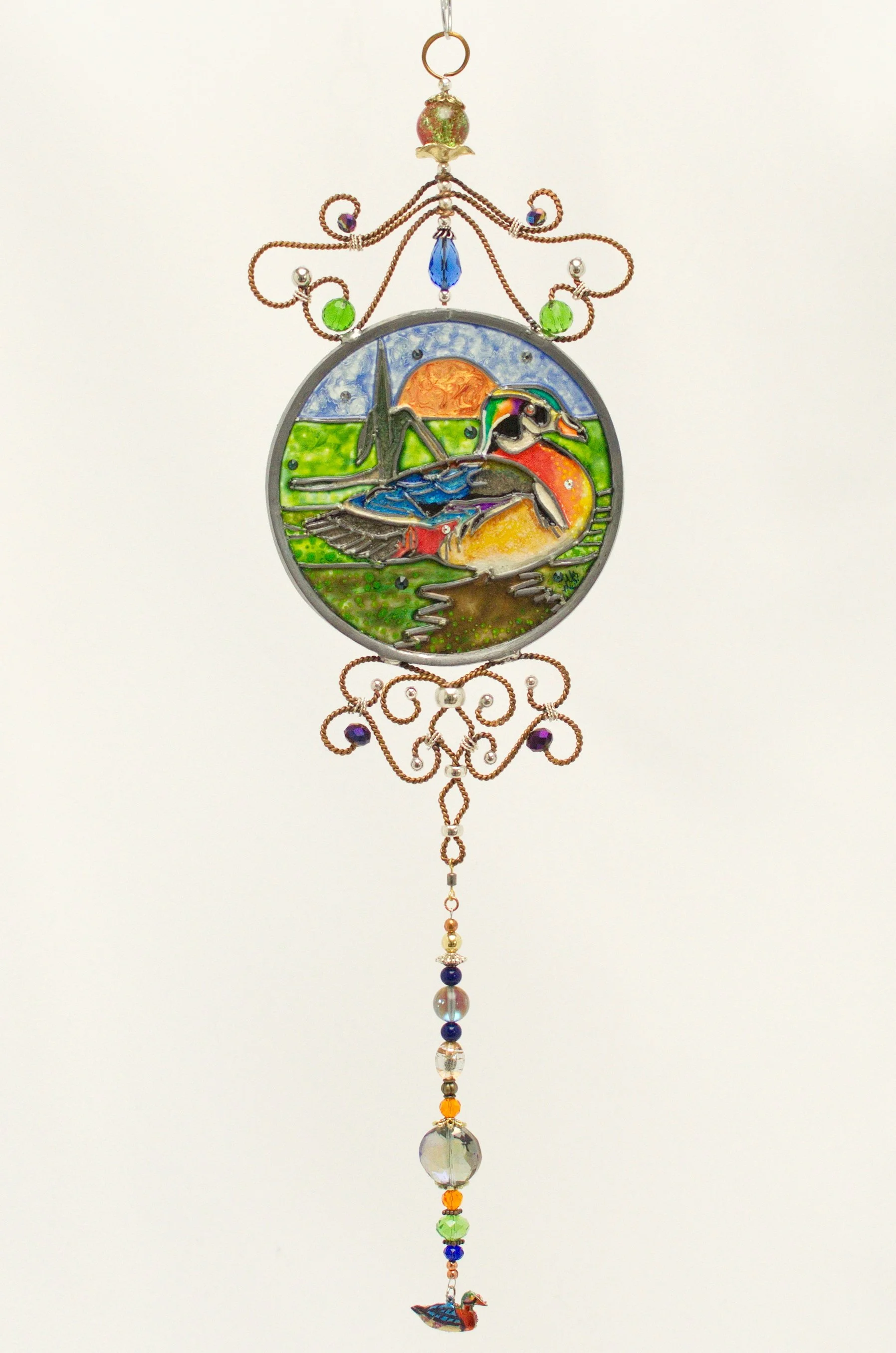 🟢 Available :
Wood Duck by Art Illusions by Young. A handsome wood duck glides gracefully among cattails and reeds in this hand-painted and leaded Illusion Glass panel. The male’s striking iridescent plumage—rich greens, deep chestnuts, and crisp wh