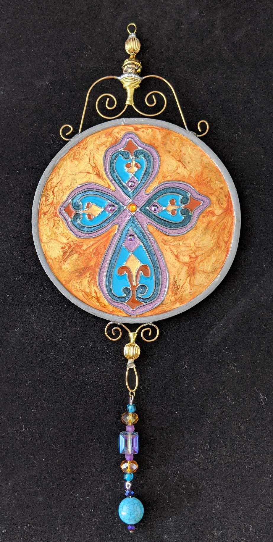 🔴 Sold: 
Cross Illusion Glass by Art Illusions by Young. An ornate cross with turquoise and gold detailing shines in this circular suncatcher. The rich color palette and intricate design create a luminous symbol of faith and elegance.