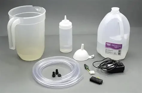 Medical suction machine with transparent collection jar, suction canister, tubing, filter, and power supply.