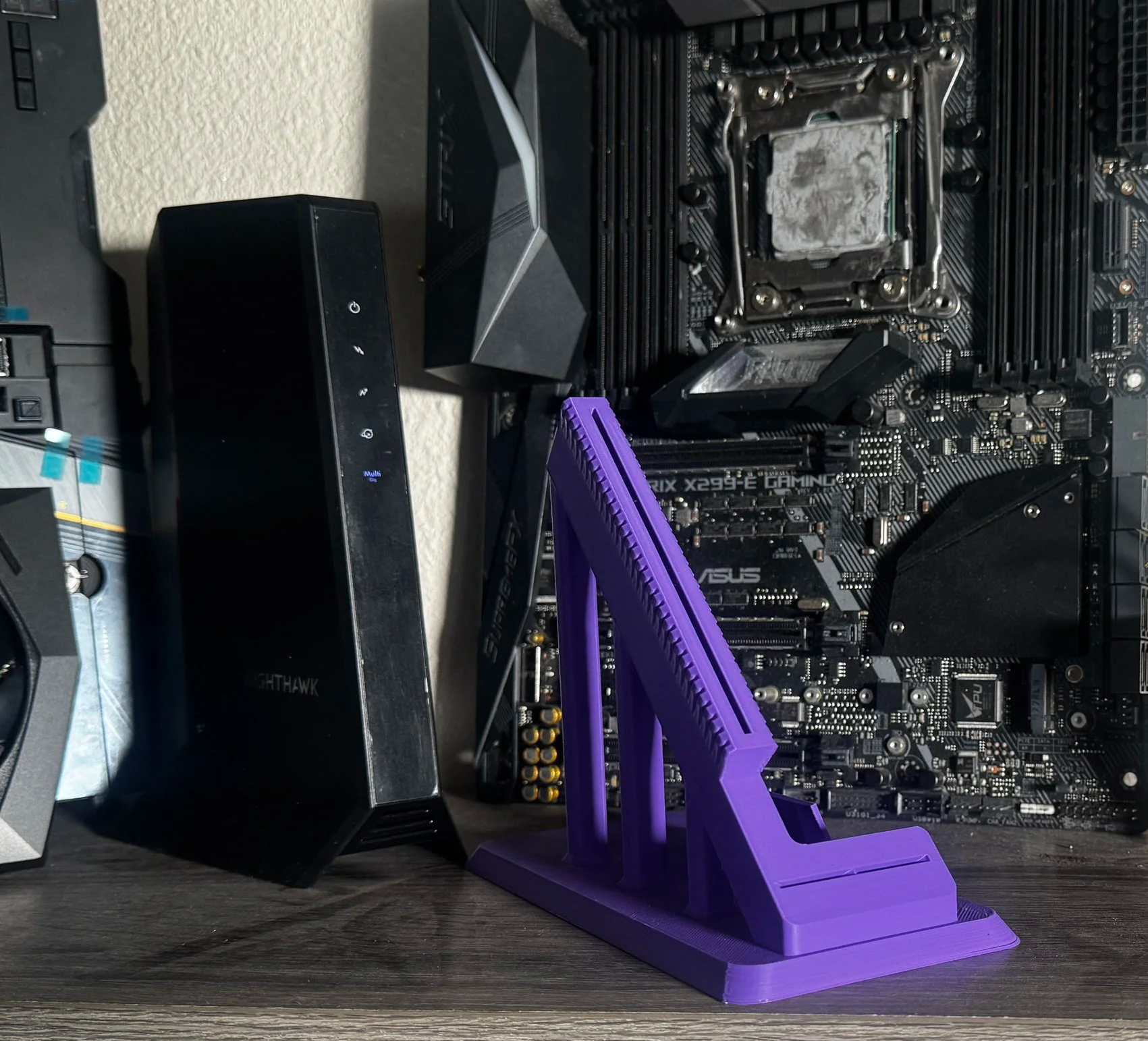 Computer motherboard with a purple stand in front of it.