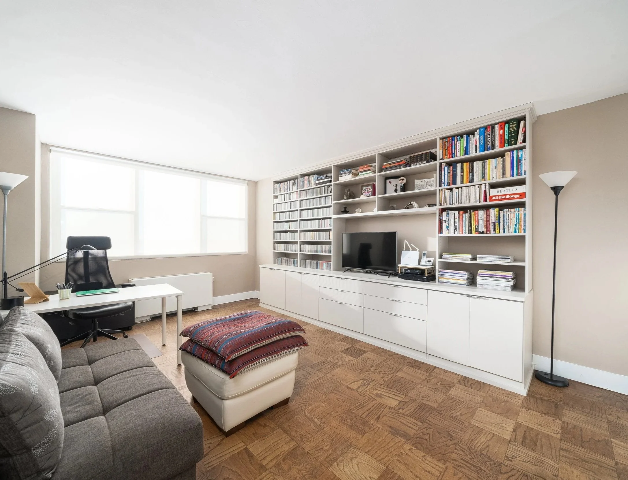 Home office redesign featuring custom built-in storage, a functional workspace, comfortable seating, and thoughtful organization for everyday productivity.