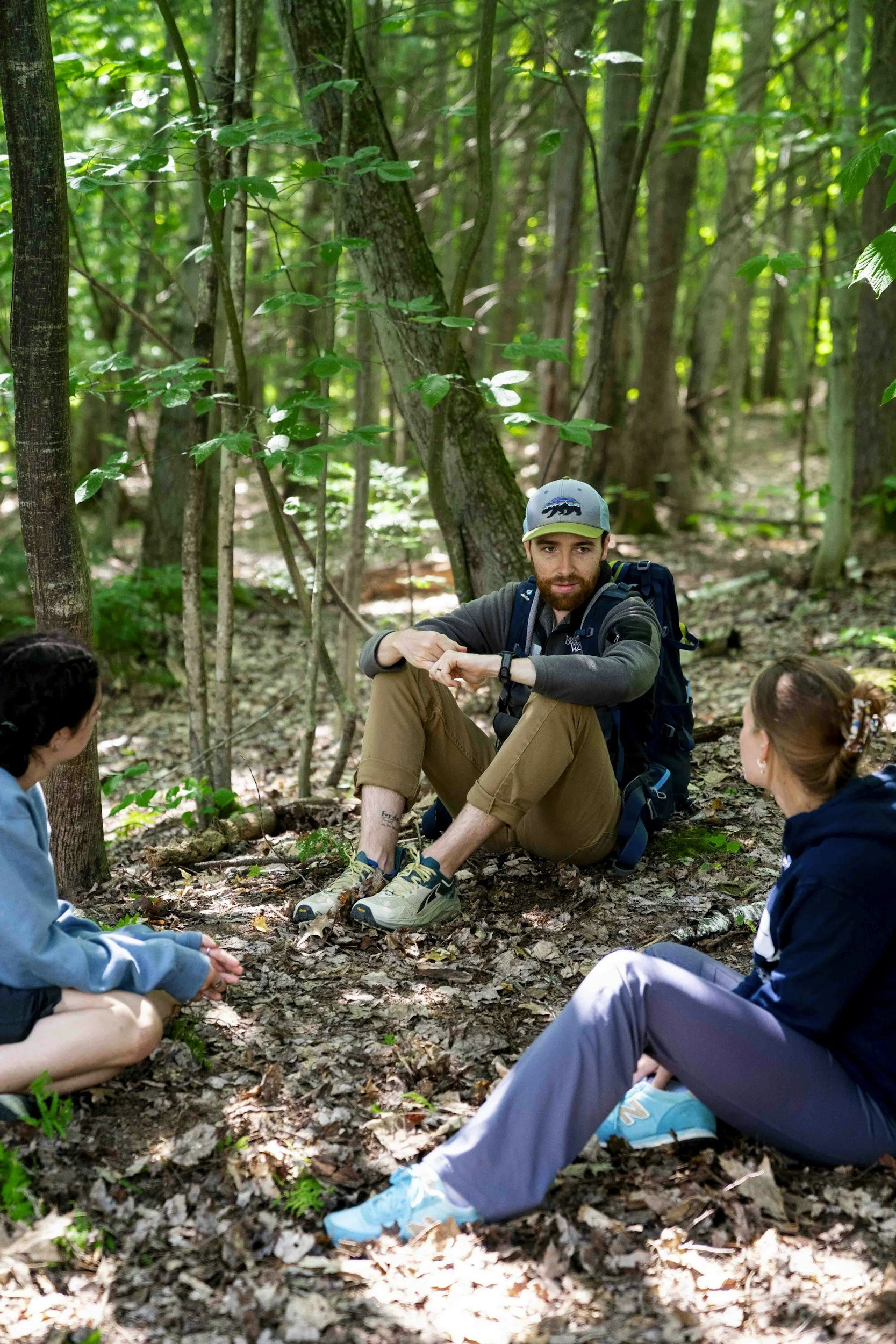 Expanded learning instructor leading an outdoor enrichment activity with school-age children.
