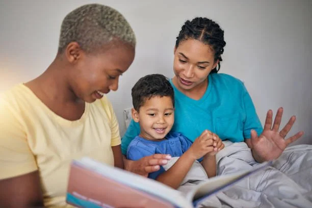 Diverse family reading together, representing positive parenting, inclusive family support, early childhood development, and school readiness.