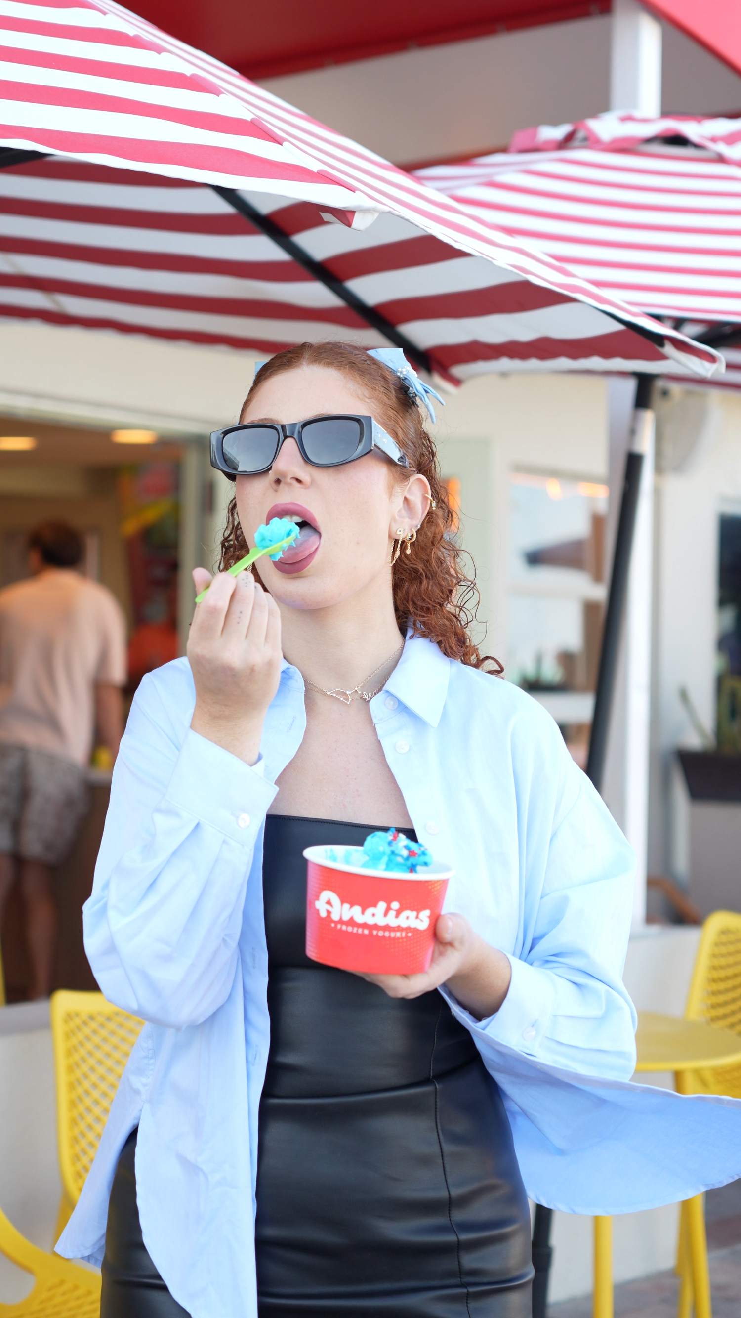 Guest enjoying frozen yogurt in an Andias branded cup