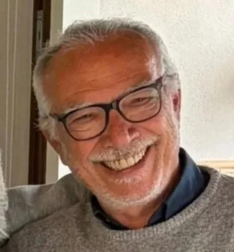 Nicola Sindoni, socio fondatore e amministratore unico, sorridente, vestito con maglione e camicia.