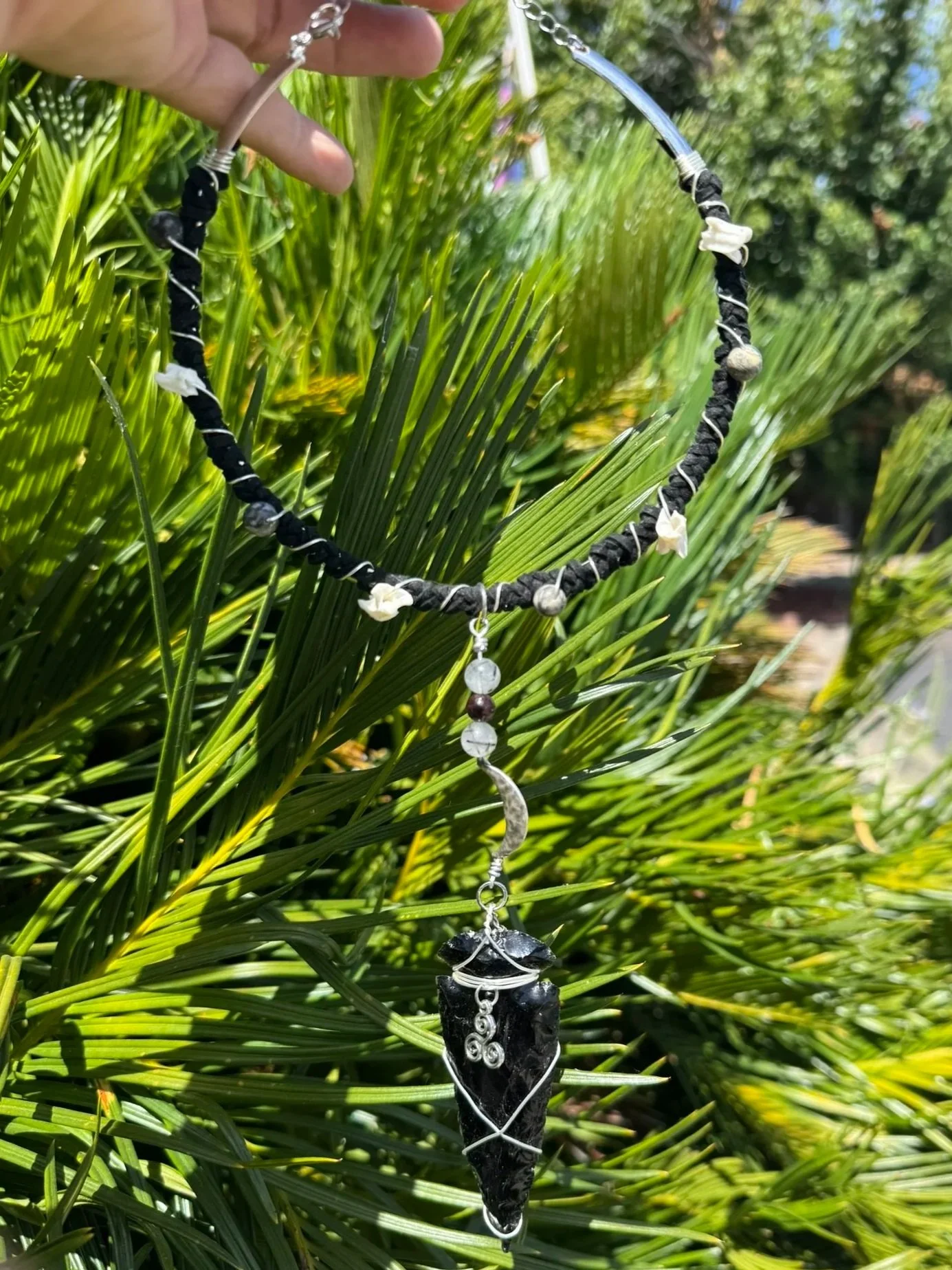 Silver plated torc necklace with stones and charms
