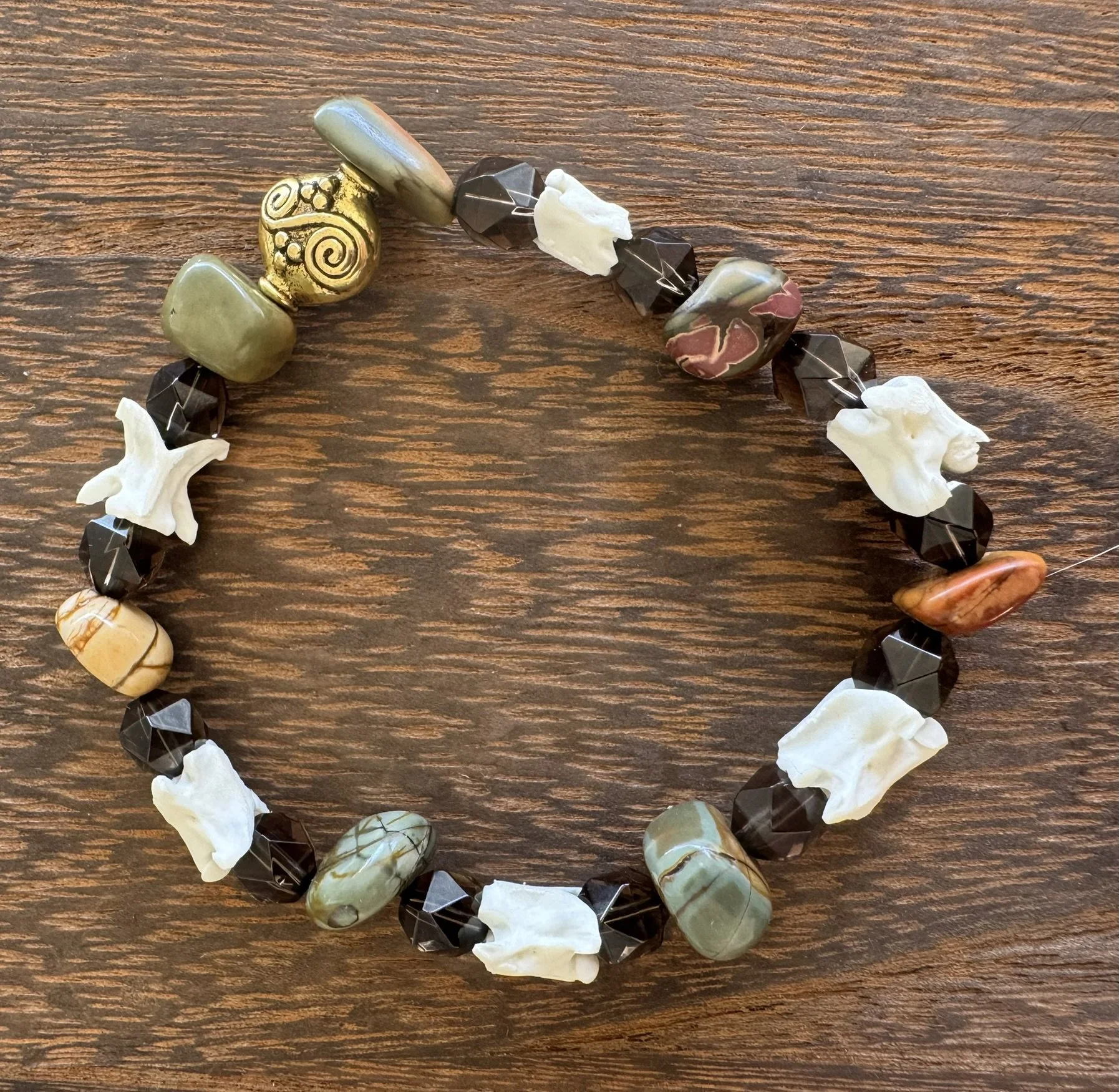 Stretchy bracelet (8 cm will fit a large wrist) with rattlesnake vertebra, picasso stone and smokey quartz beads. *SOLD*