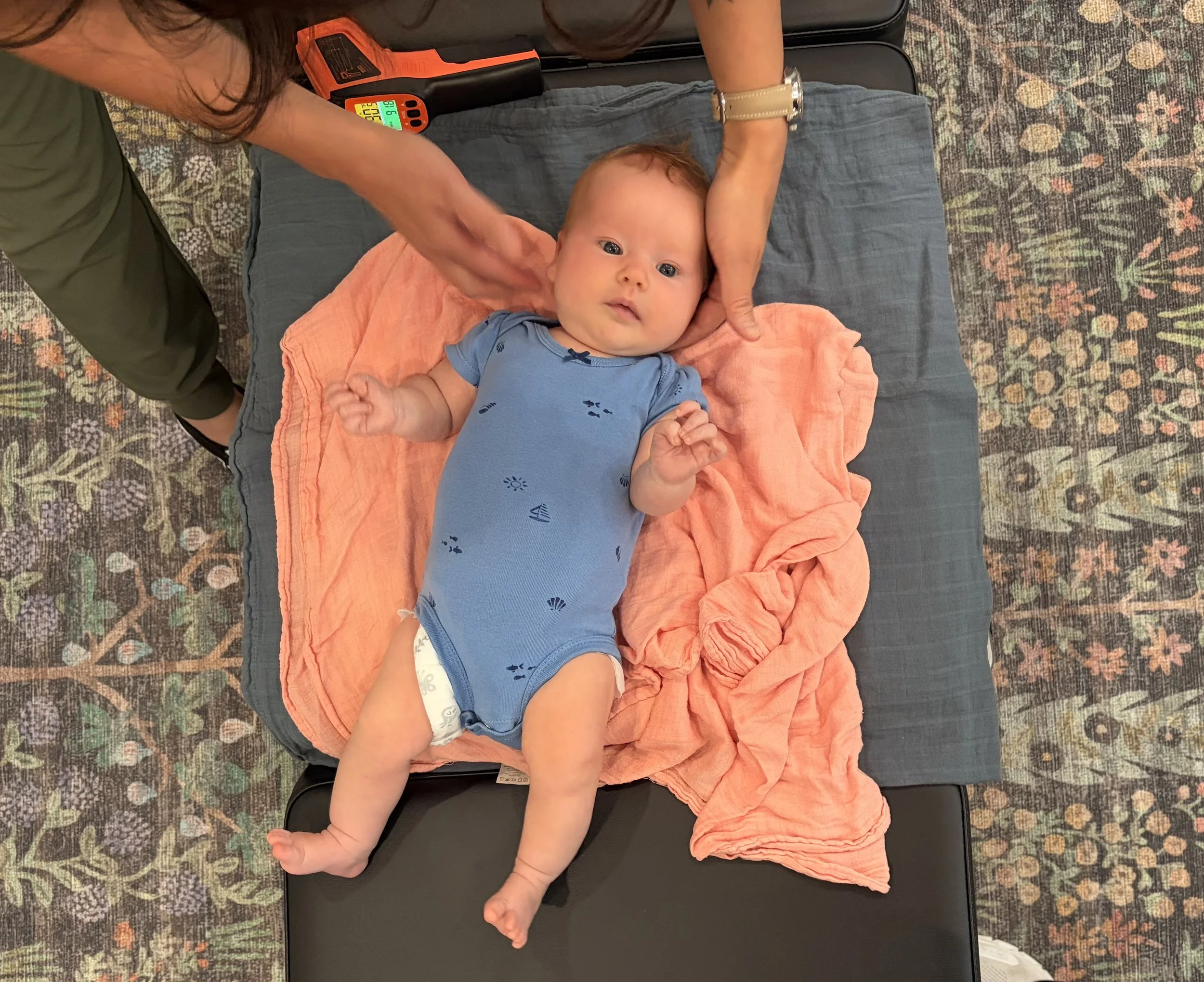 Dr. Naroth Ramos, DC gently adjusting a pediatric patient
