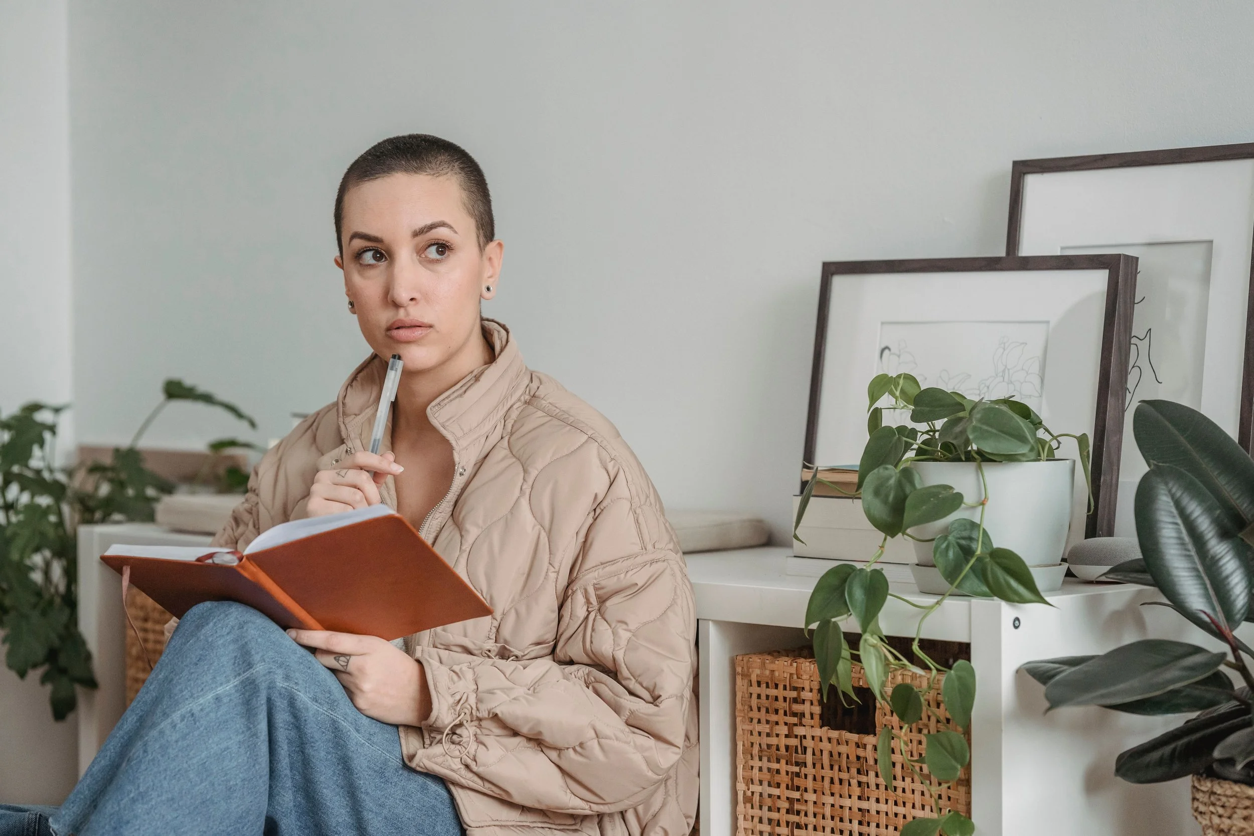 A person sitting quietly with a journal, representing the Viridian Counseling blog for neurodivergent adults in Connecticut