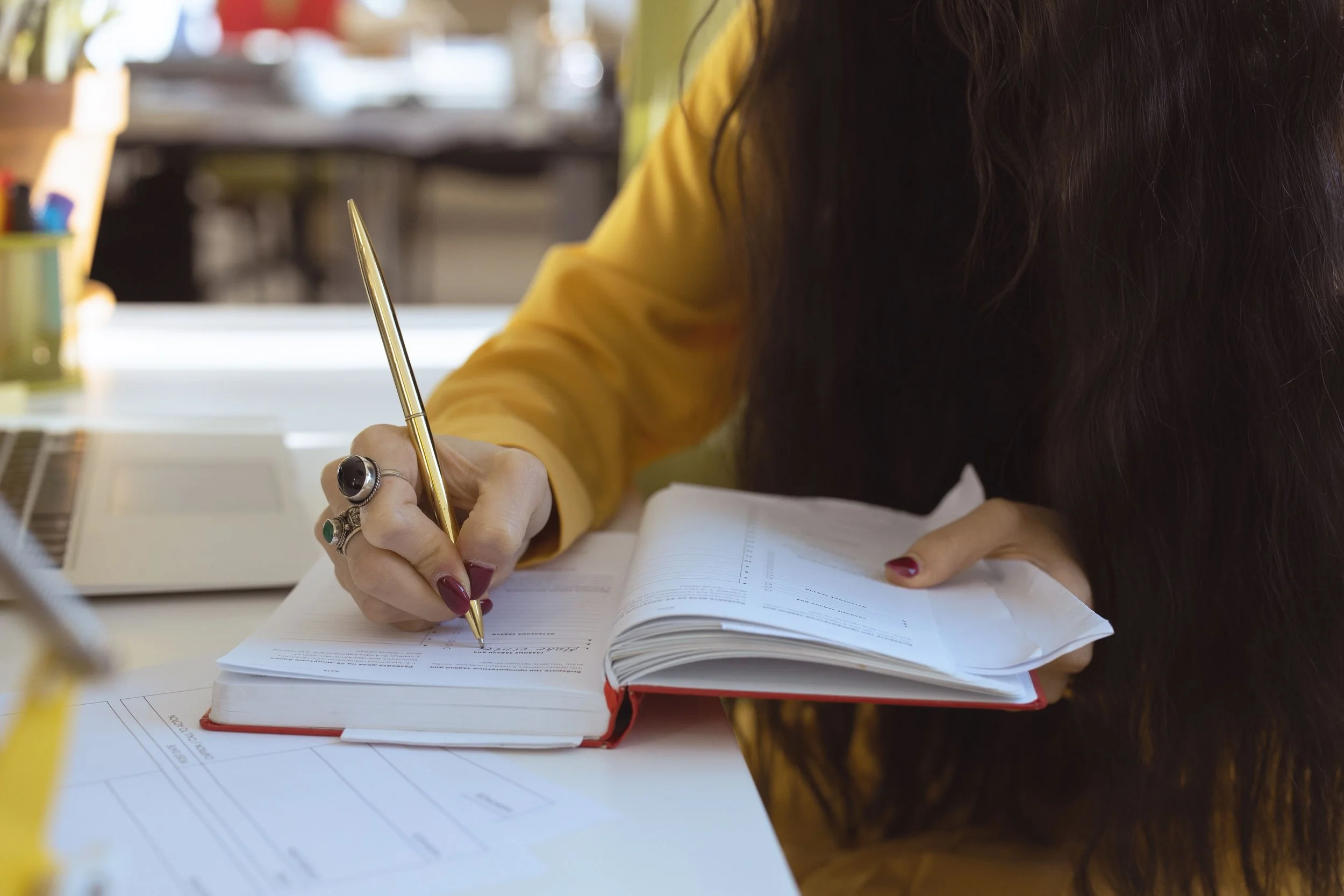 A person writing in a journal with focused calm, representing executive functioning support and ADHD therapy strategies in Connecticut