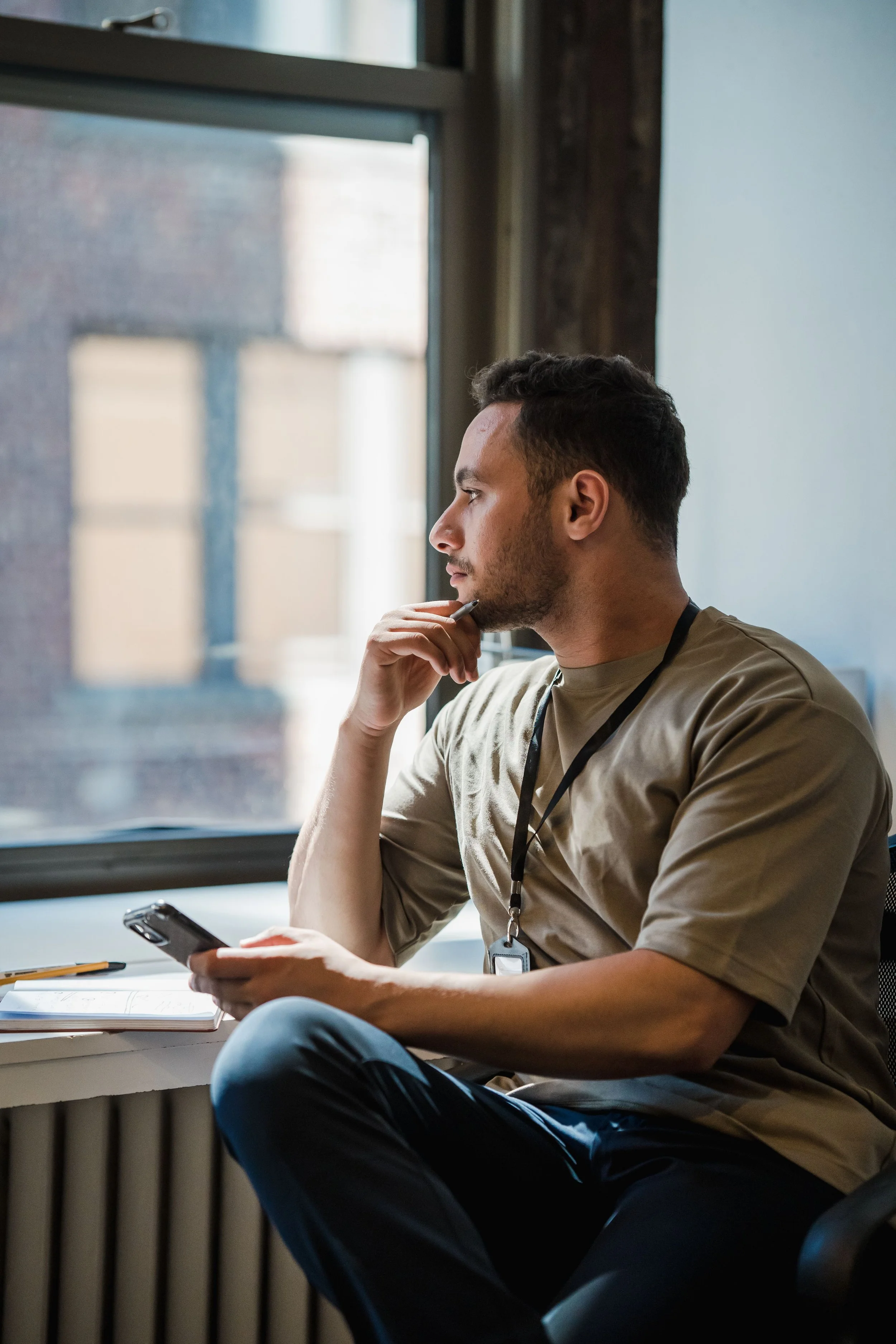 A person sitting calmly near a window with natural light, representing the relief of taking the first step toward identity and boundaries therapy in Connecticut