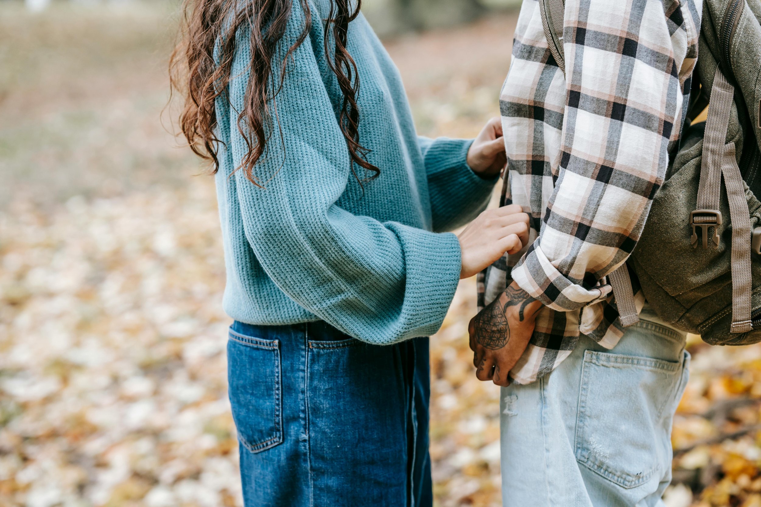 A couple walking outdoors holding hands, representing couples therapy for role and capacity imbalance in Connecticut