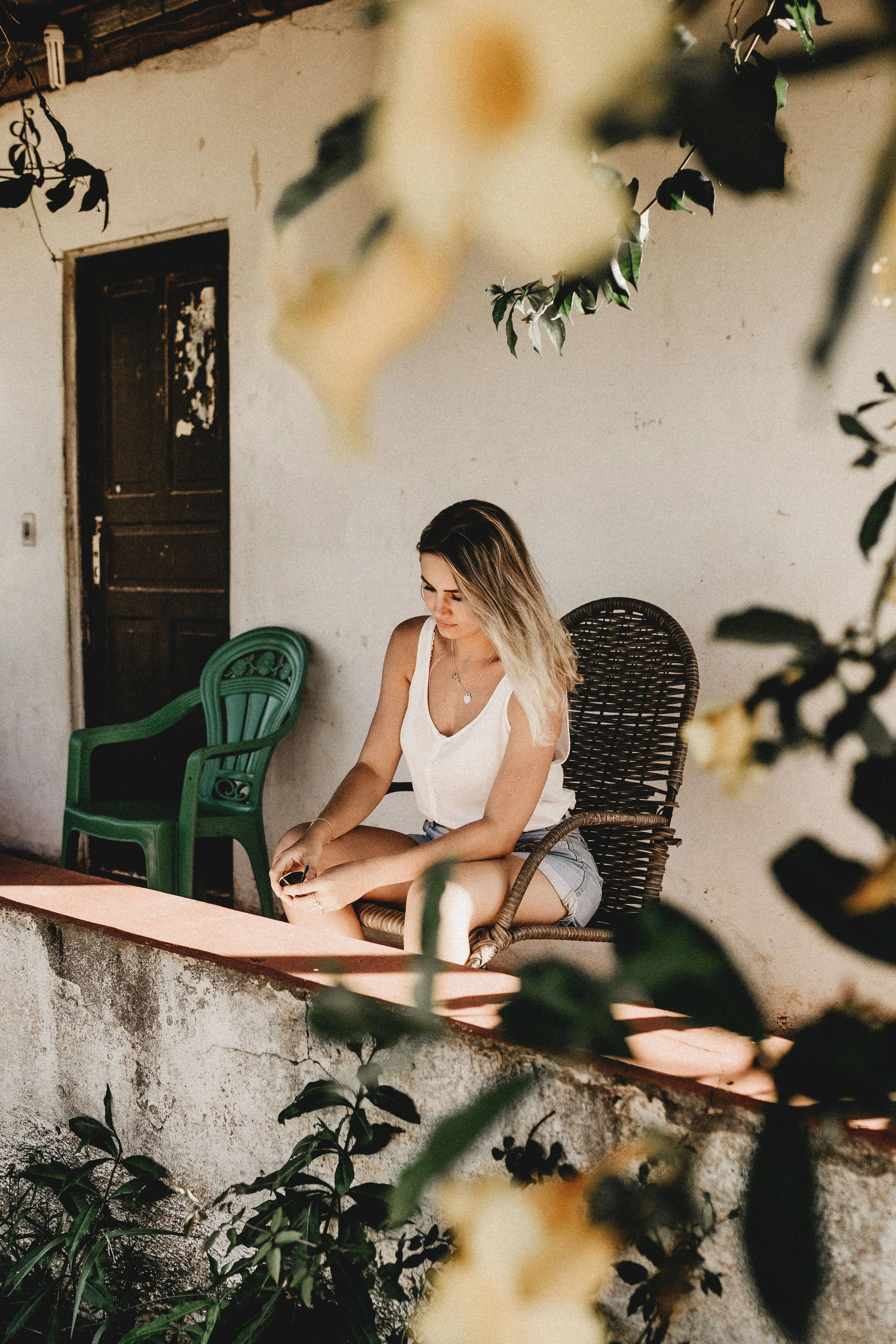 A person sitting quietly outside in natural light, representing the early stages of burnout recovery and rest for high-functioning adults in Connecticut